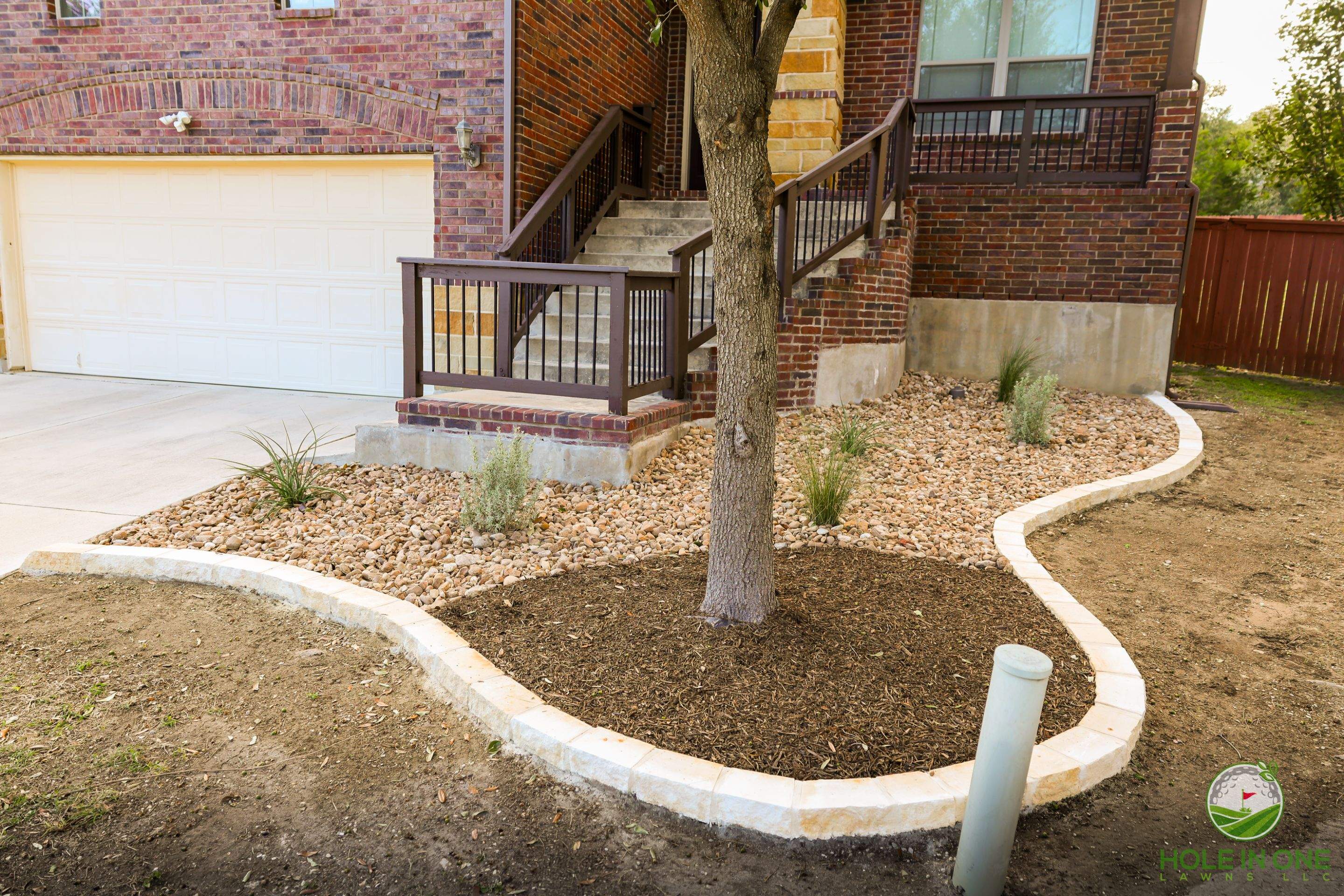Low-Maintenance Front Yard Xeriscape with Chopstone Border, North San Antonio TX by Hole In One Lawns, LLC