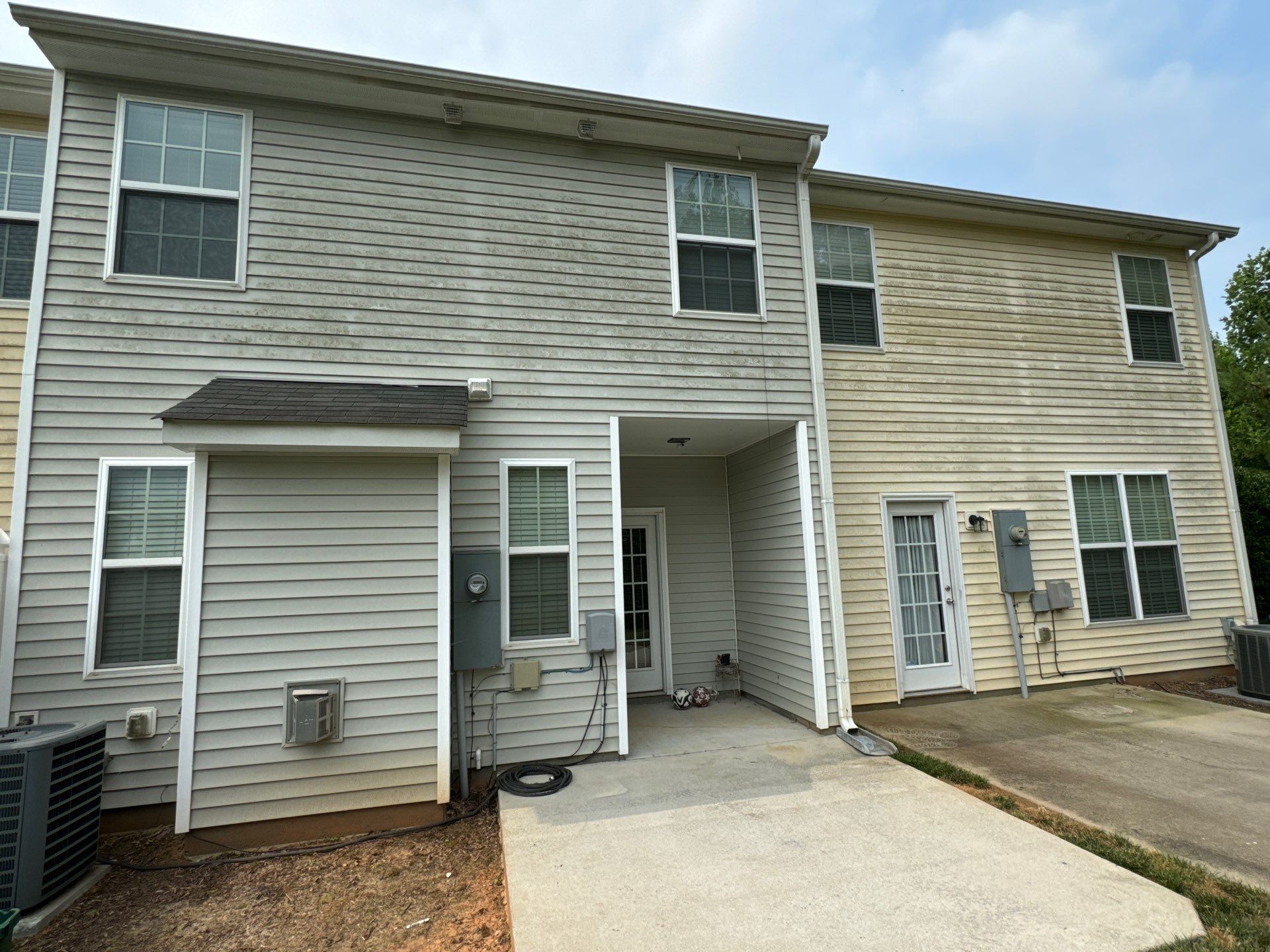 pressure washing exterior siding and concrete sidewalks to remove dirt and mildew