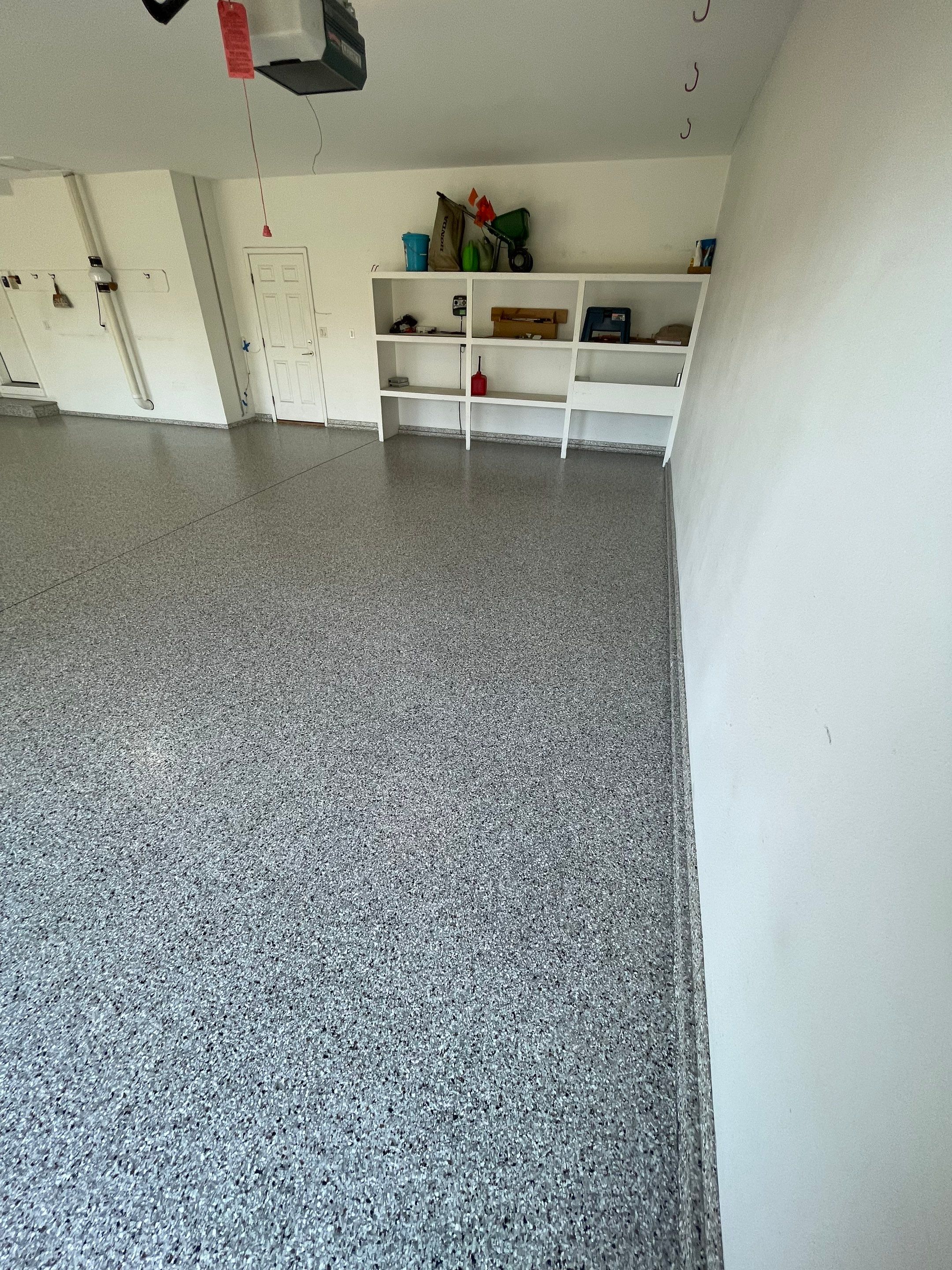 Yankton Garage Floor Restoration with Gray Speckled Epoxy Coating by Select Painting, Coatings & Garage Cabinets