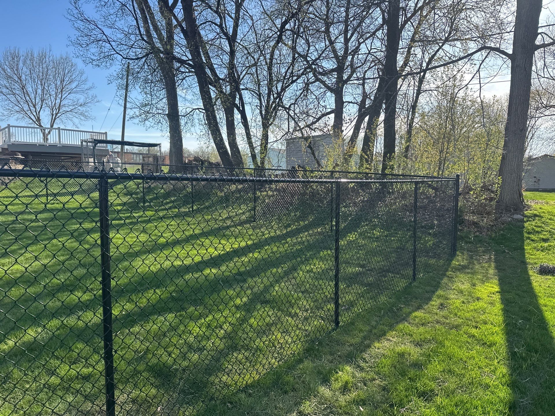 Black Vinyl-Coated Chain Link Fence Installation in Waterloo by Perfect Picket Fence and Stain