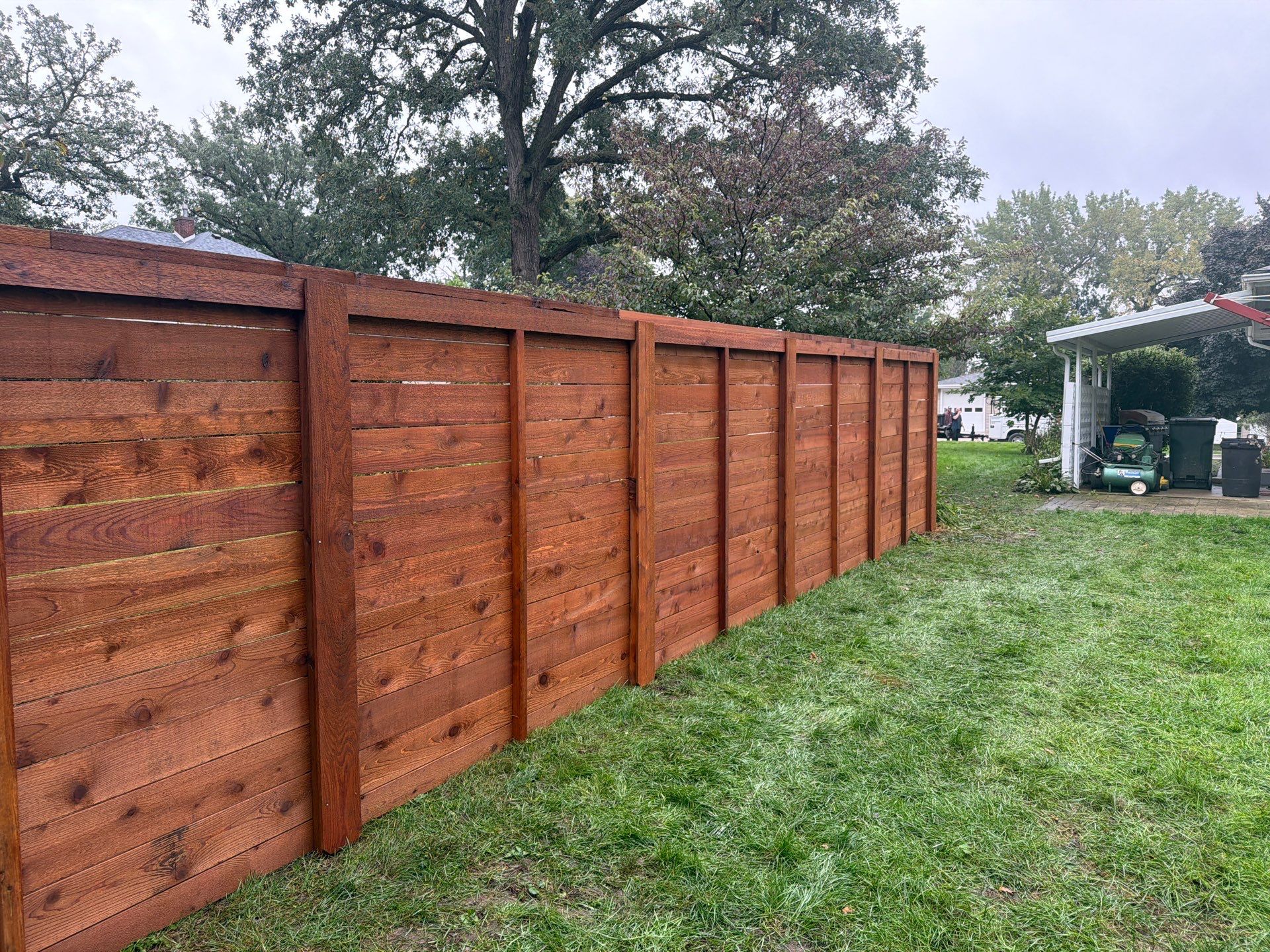 Stained Horizontal Cedar Wood Privacy Fence in Cedar Falls by Perfect Picket Fence and Stain