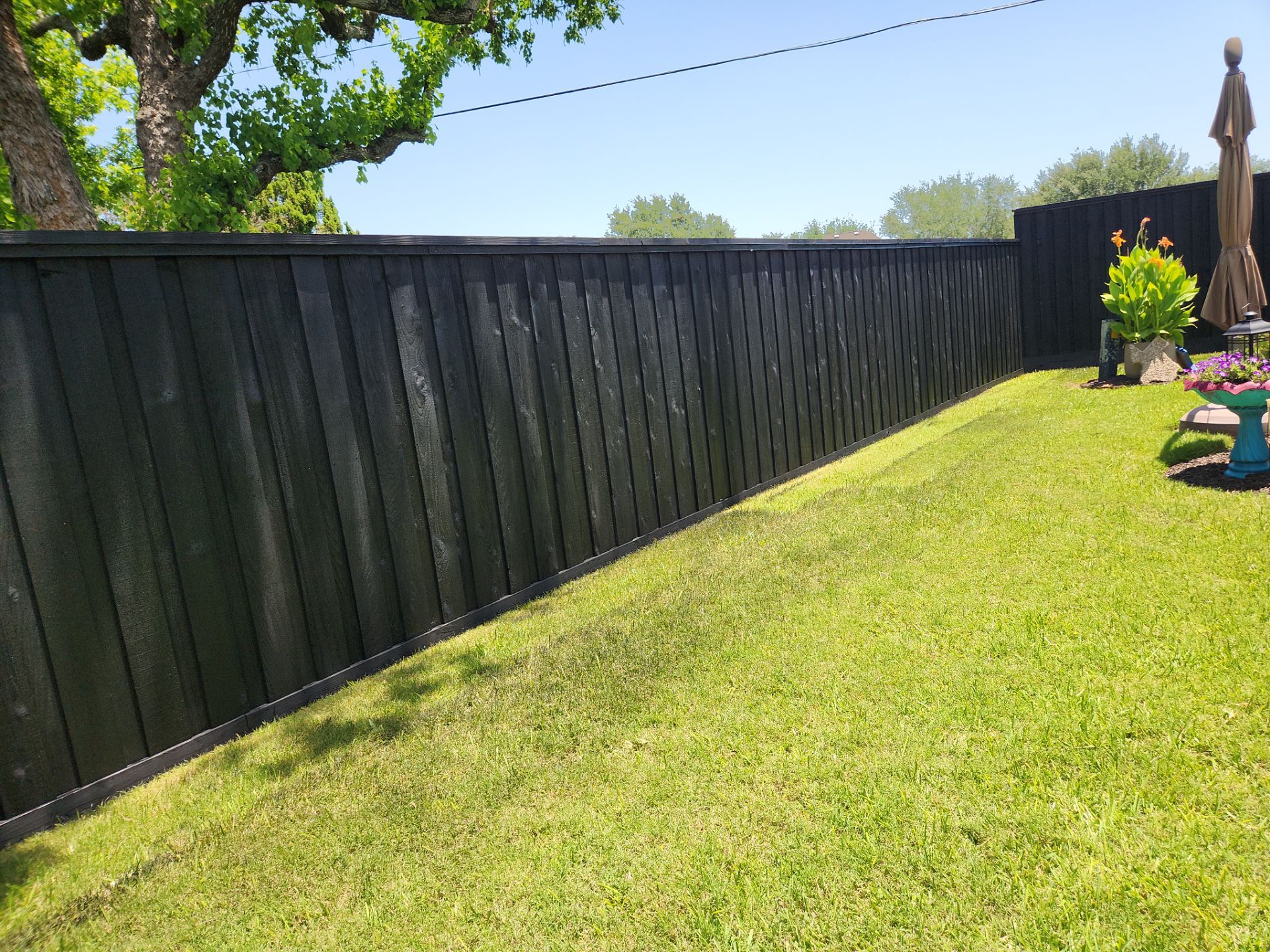 Modern Black Fence Finish by Tim's Fences