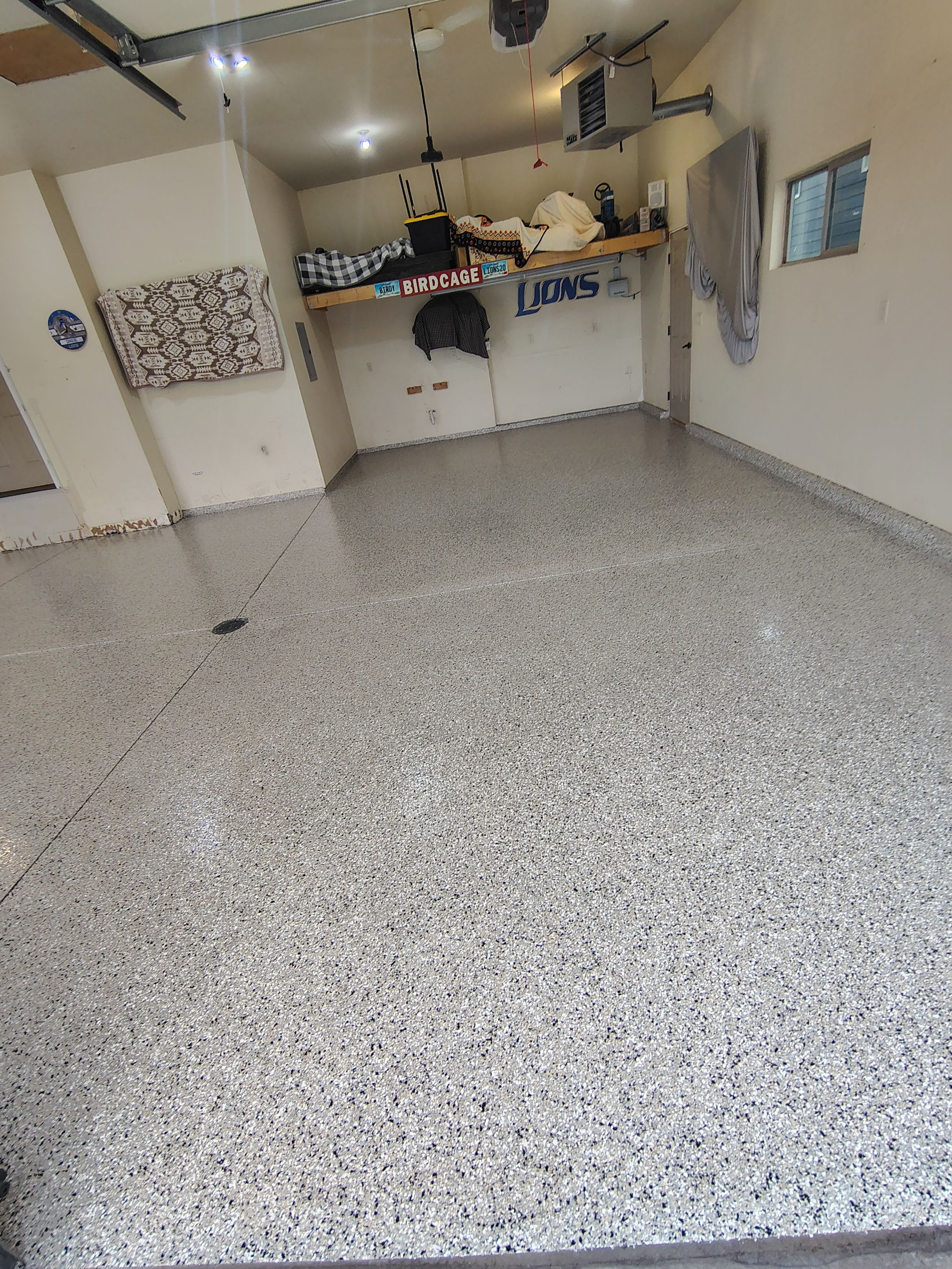 Sioux Falls Garage Floor Repair and Speckled Epoxy Coating Installation by Select Painting, Coatings & Garage Cabinets