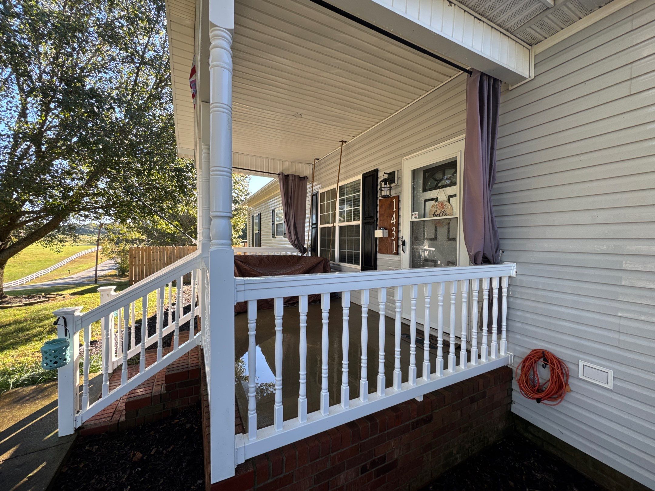 the service being done is cleaning the porch railings and steps along with the exterior siding of the house