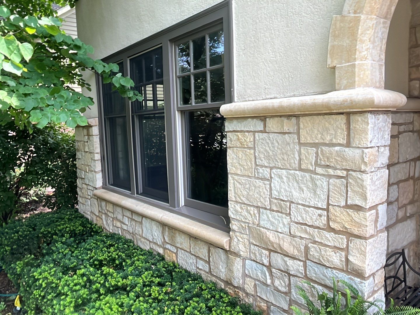 Northbrook, IL stucco home soft wash and stone cleaning by Northern Power Washing LLC.