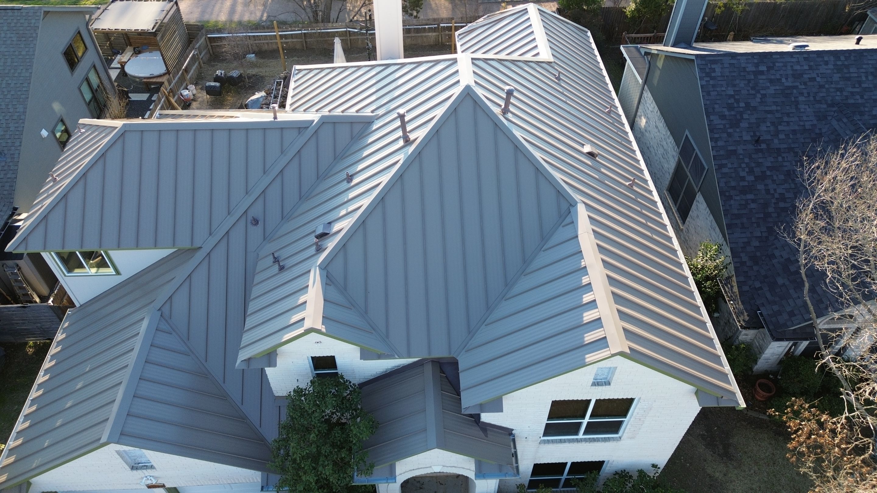 Three Tab Shingles To Metal Standing Seam by DeZign Roofing & Exteriors