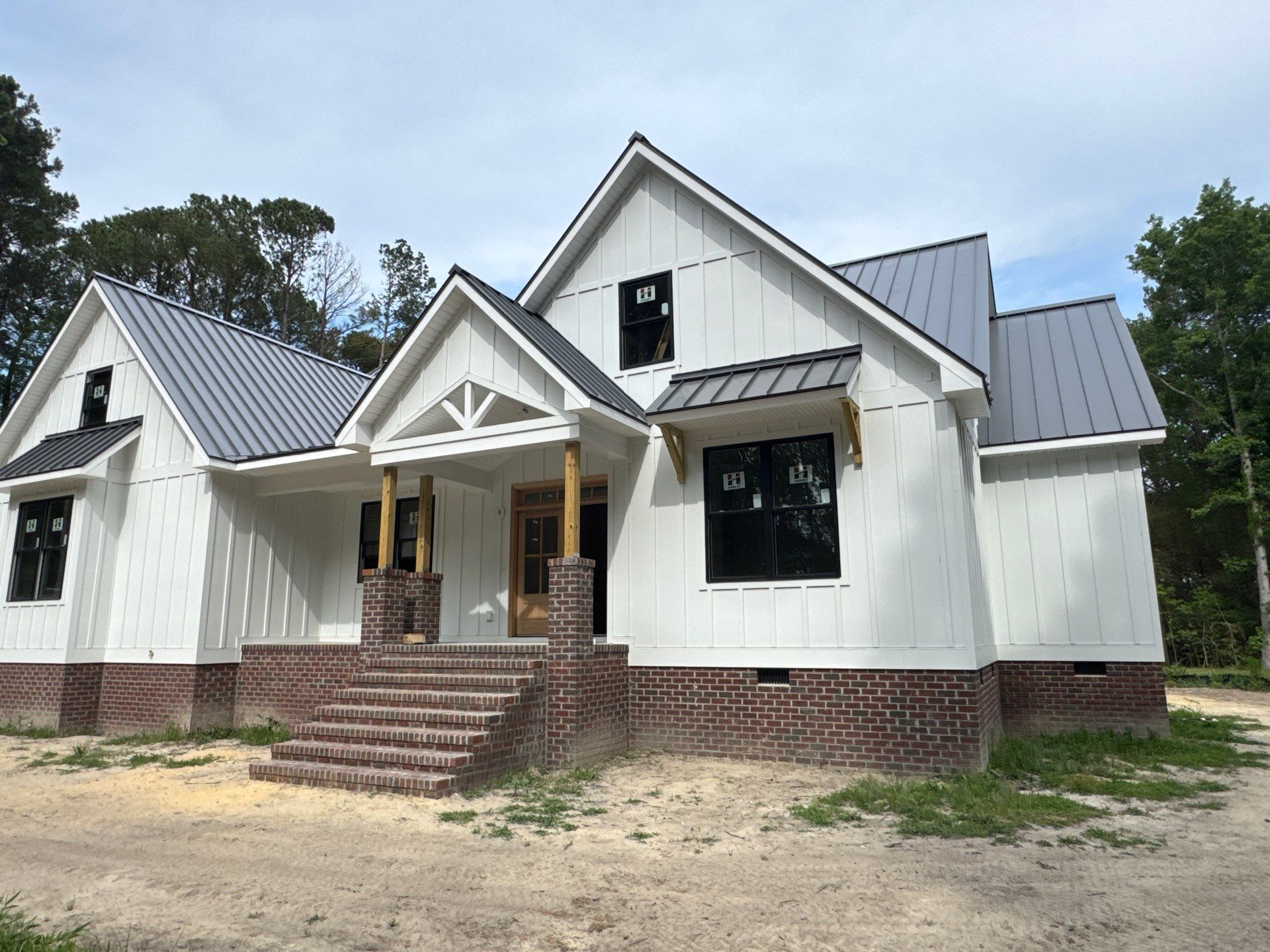 Custom New Construction Home Featuring Standing Seam Metal Roofing in Port Haywood by Cade Construction