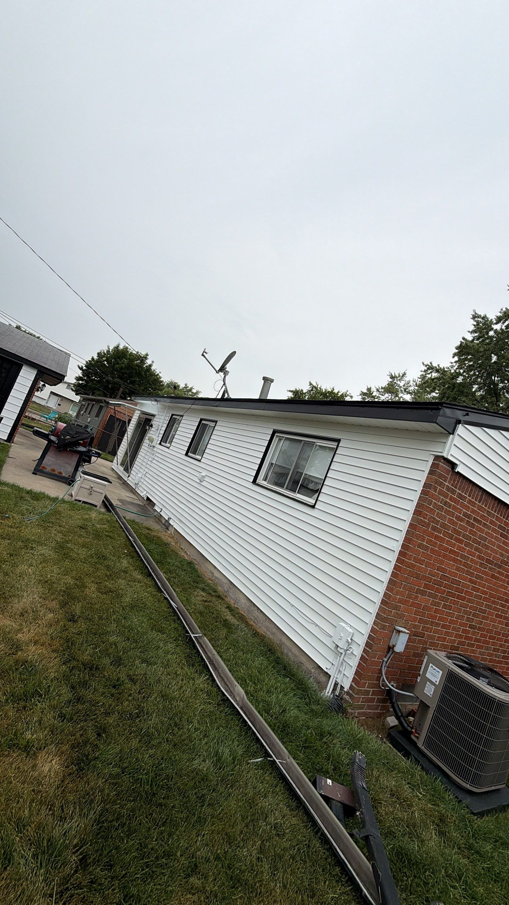 White Vinyl Siding and Gutter Installation in Sterling Heights by Top Shelf Painter