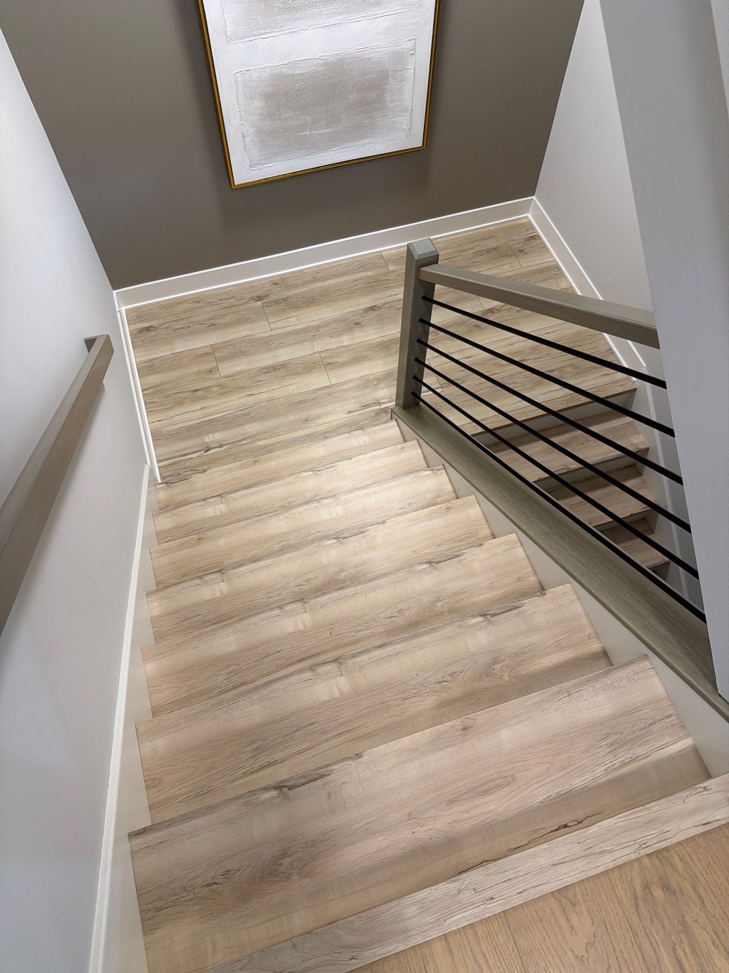 Fishers Staircase Renovation Featuring Custom Herringbone Runner and Modern Railing by Brothers Floor Covering INC.