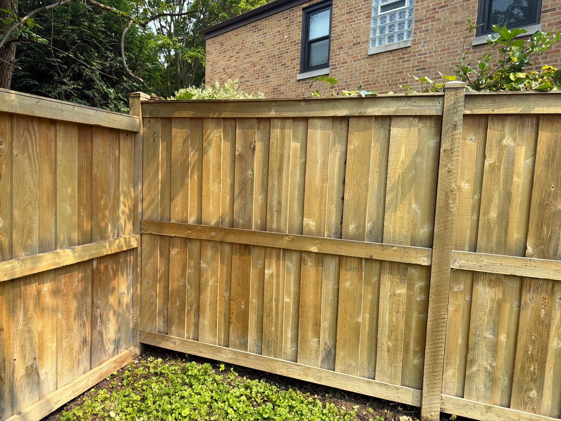 Wood fence cleaning and sealing by Northern Power Washing LLC.