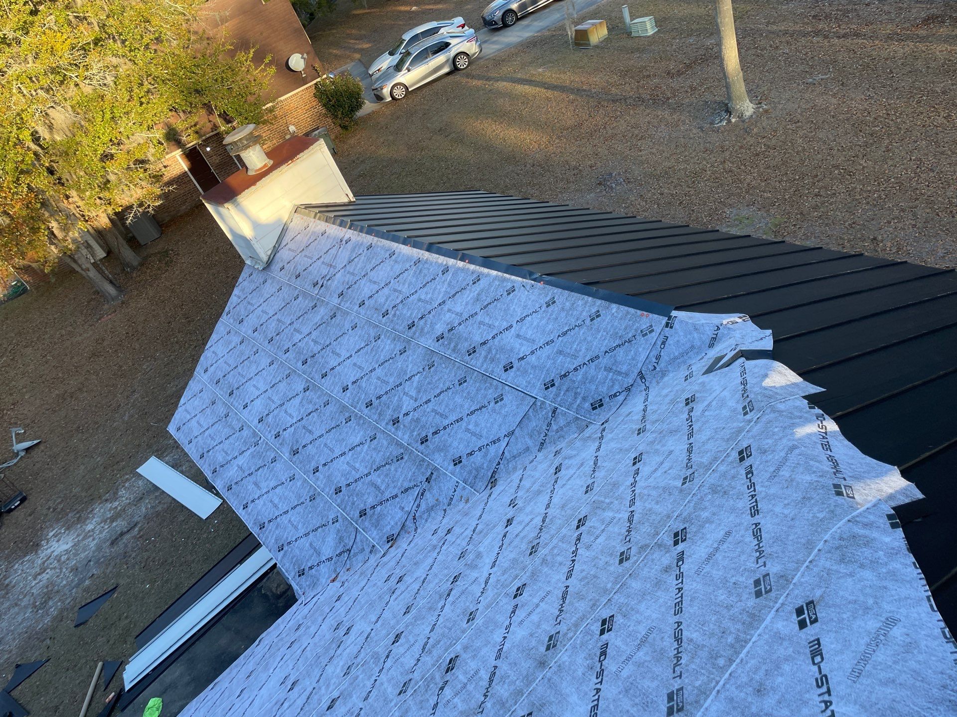 Residential Roofing Installation using Benton 26Ga 1inc Snapcock Metal Roof KYNAR Matte Black by Talya Roofing