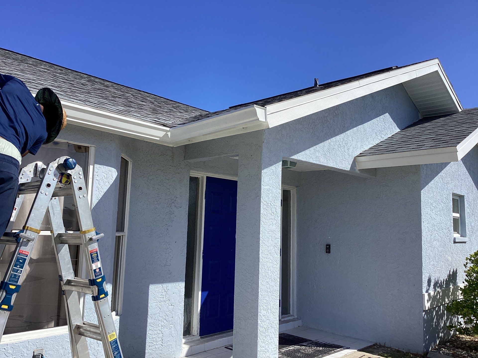 New White Seamless Gutters with Downspouts and Splash Guards in Cape Coral FL by Gutter Professors