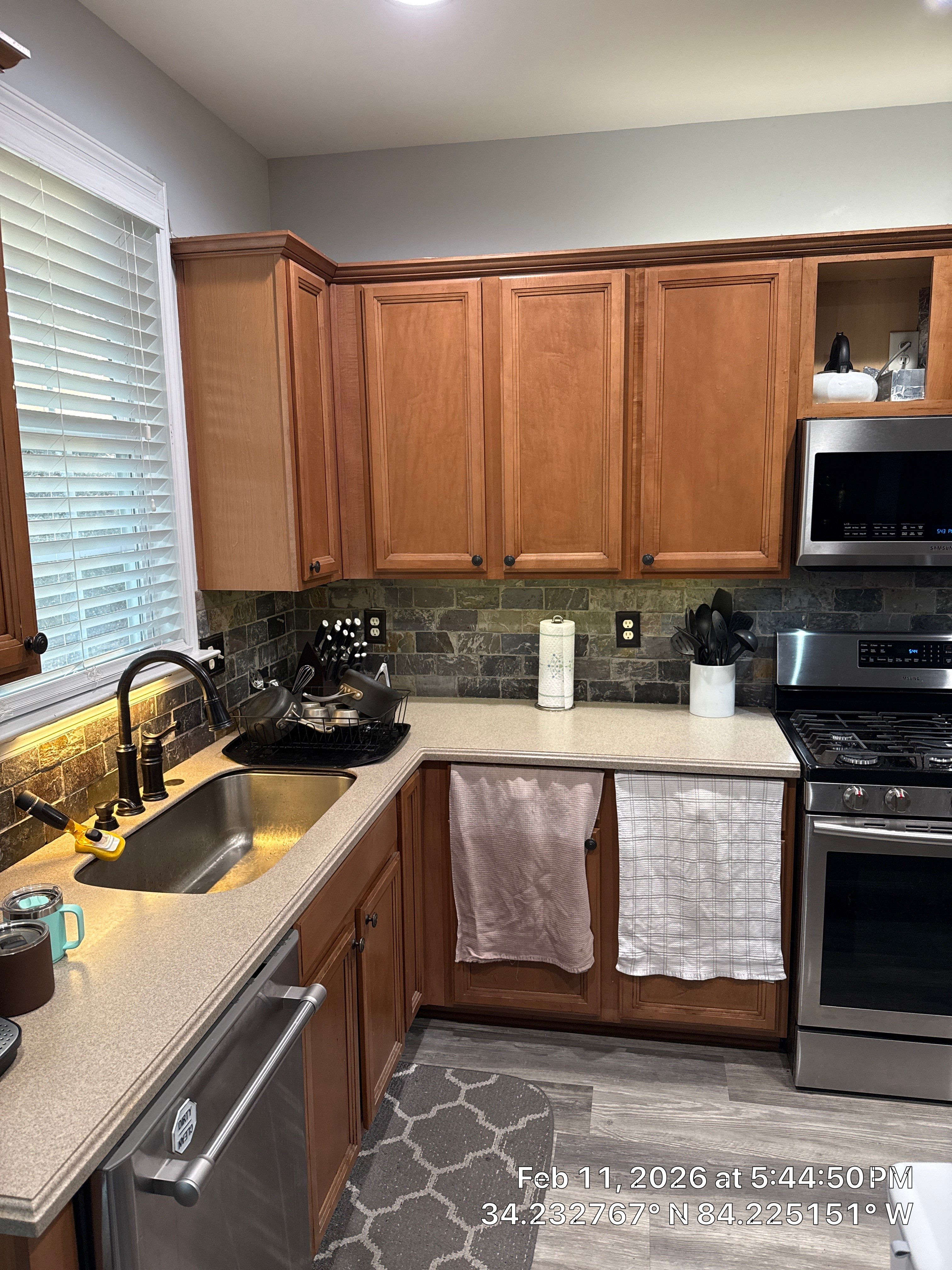 Modern Kitchen Remodel With Grey Shaker Cabinets and Navy Blue Island by Heart & Home Kitchen & Bath Remodeling LLC