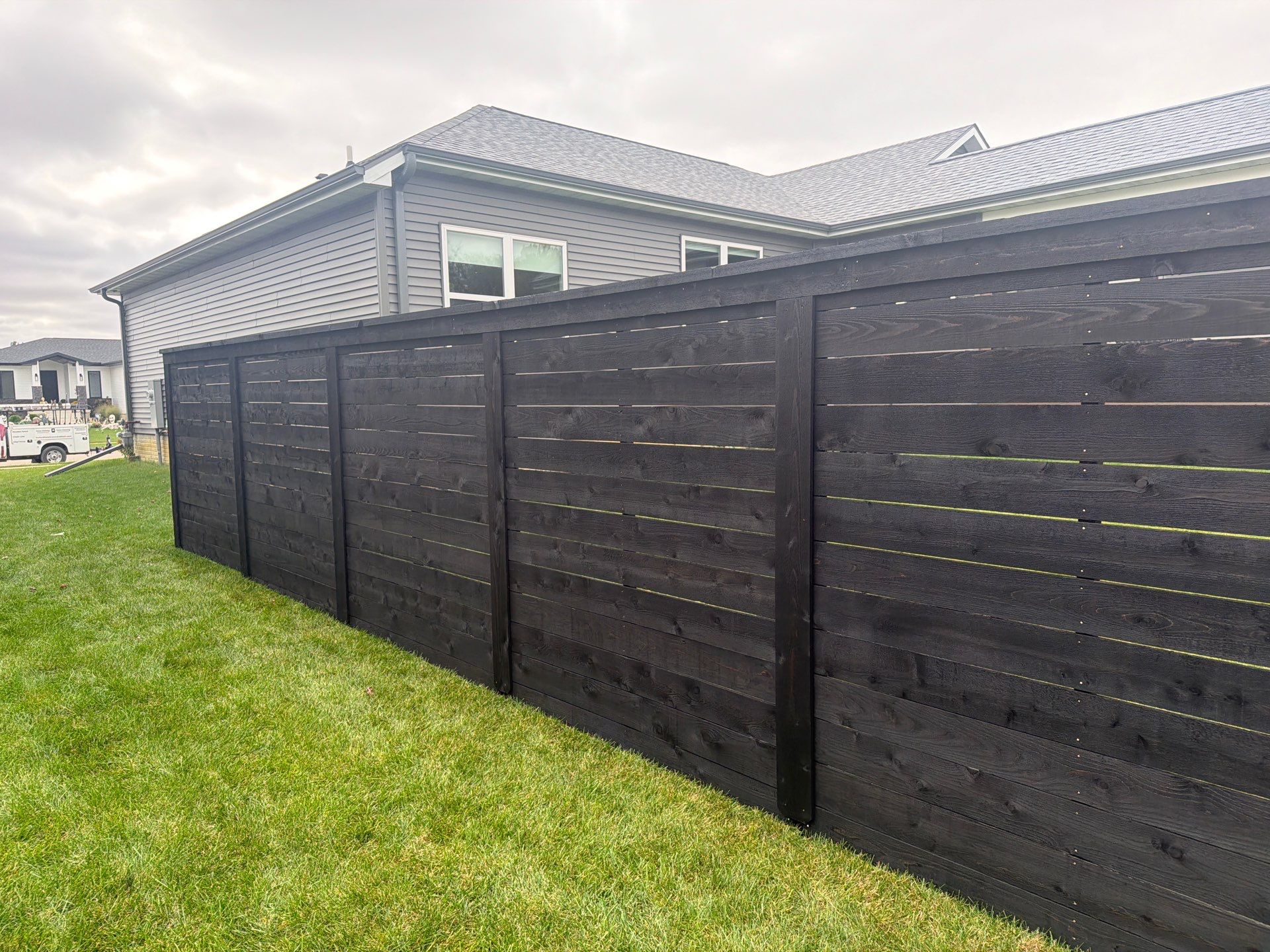 Modern Horizontal Wood Privacy Fence Installation in Cedar Falls by Perfect Picket Fence and Stain