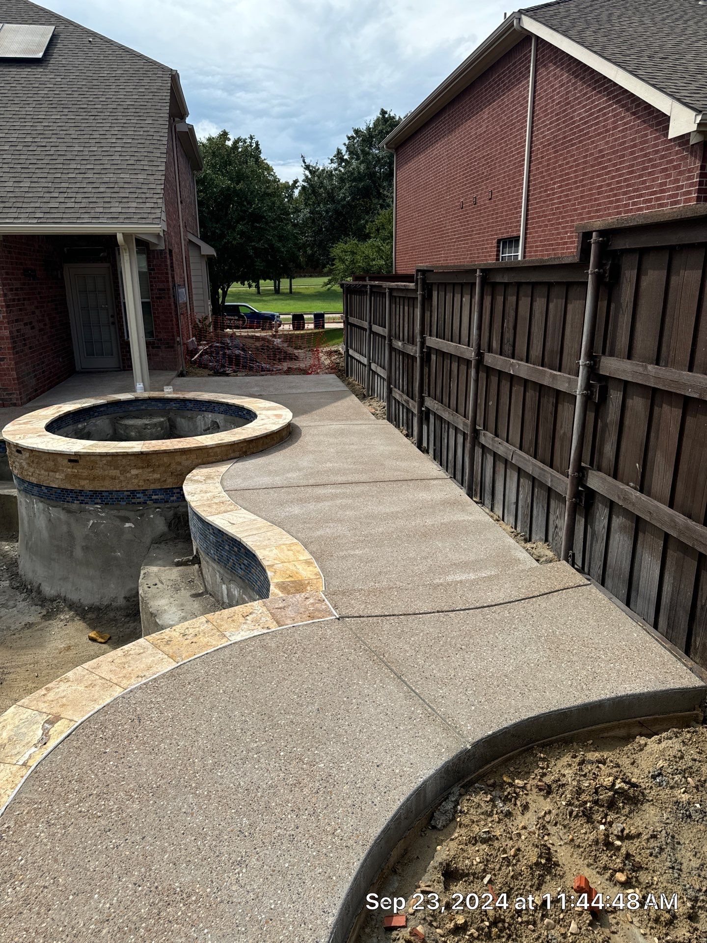 Freeform Pool and Spa with Raised Stone Water Wall by Pinnacle Pools and Spas - DFW