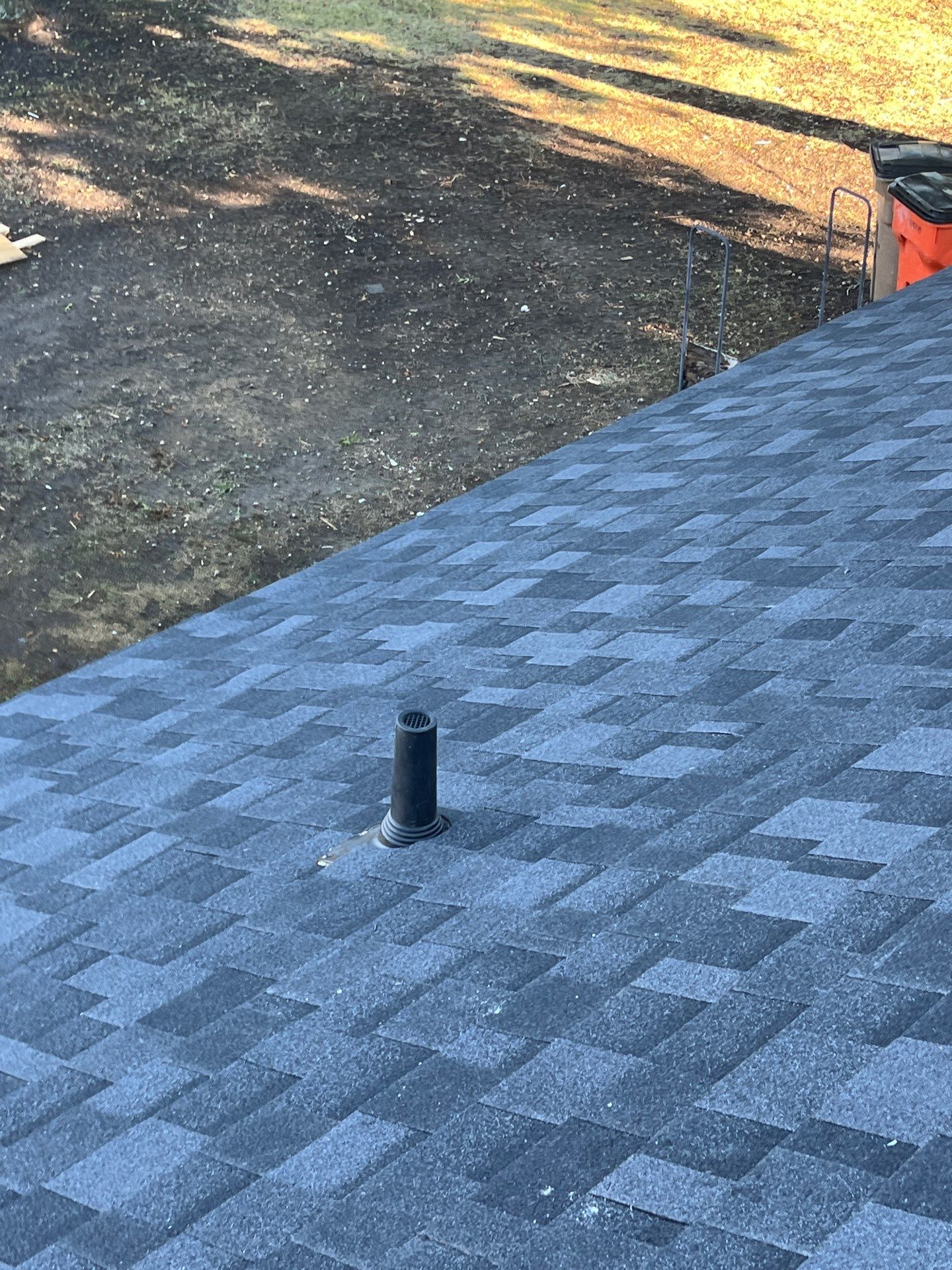 White brick with IKO Granite Black by Tejas Roofworks + Restoration