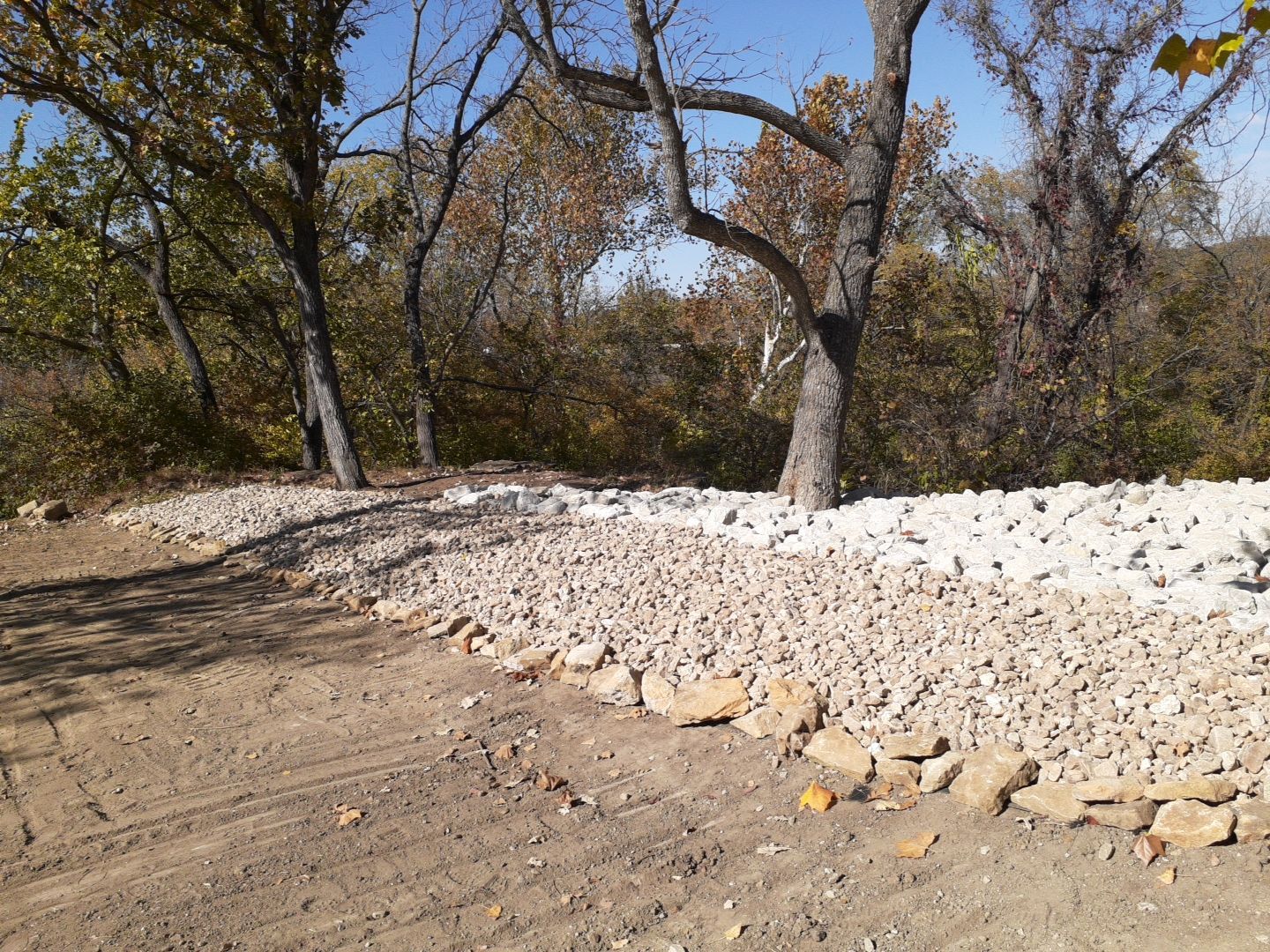 Supporting back of home with backfill at edge of steep creek by LAND ESCAPES LLC