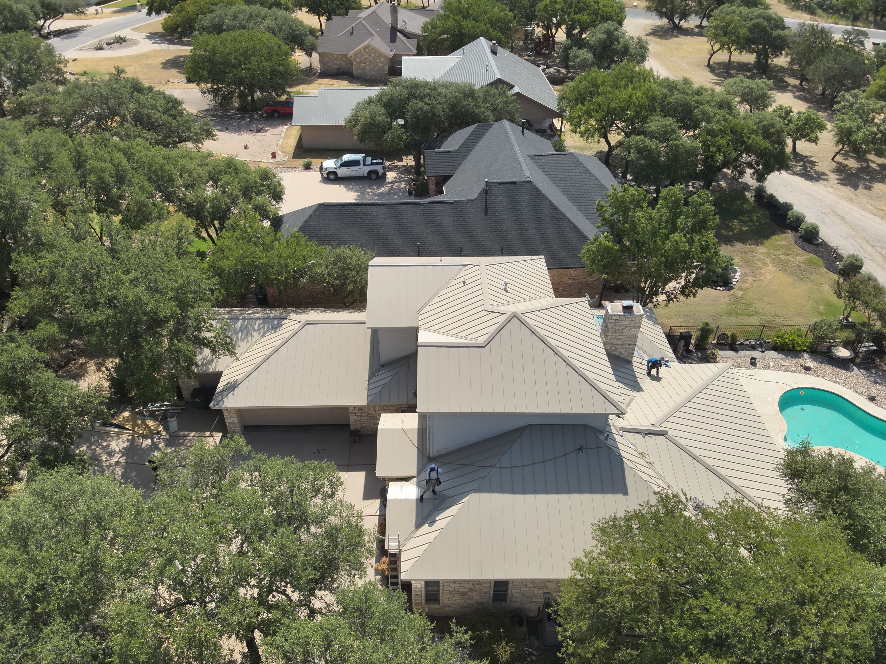 Residential Roof Replacement using 24 GA Double-Lock - Surrey Beige by Action Exteriors Austin