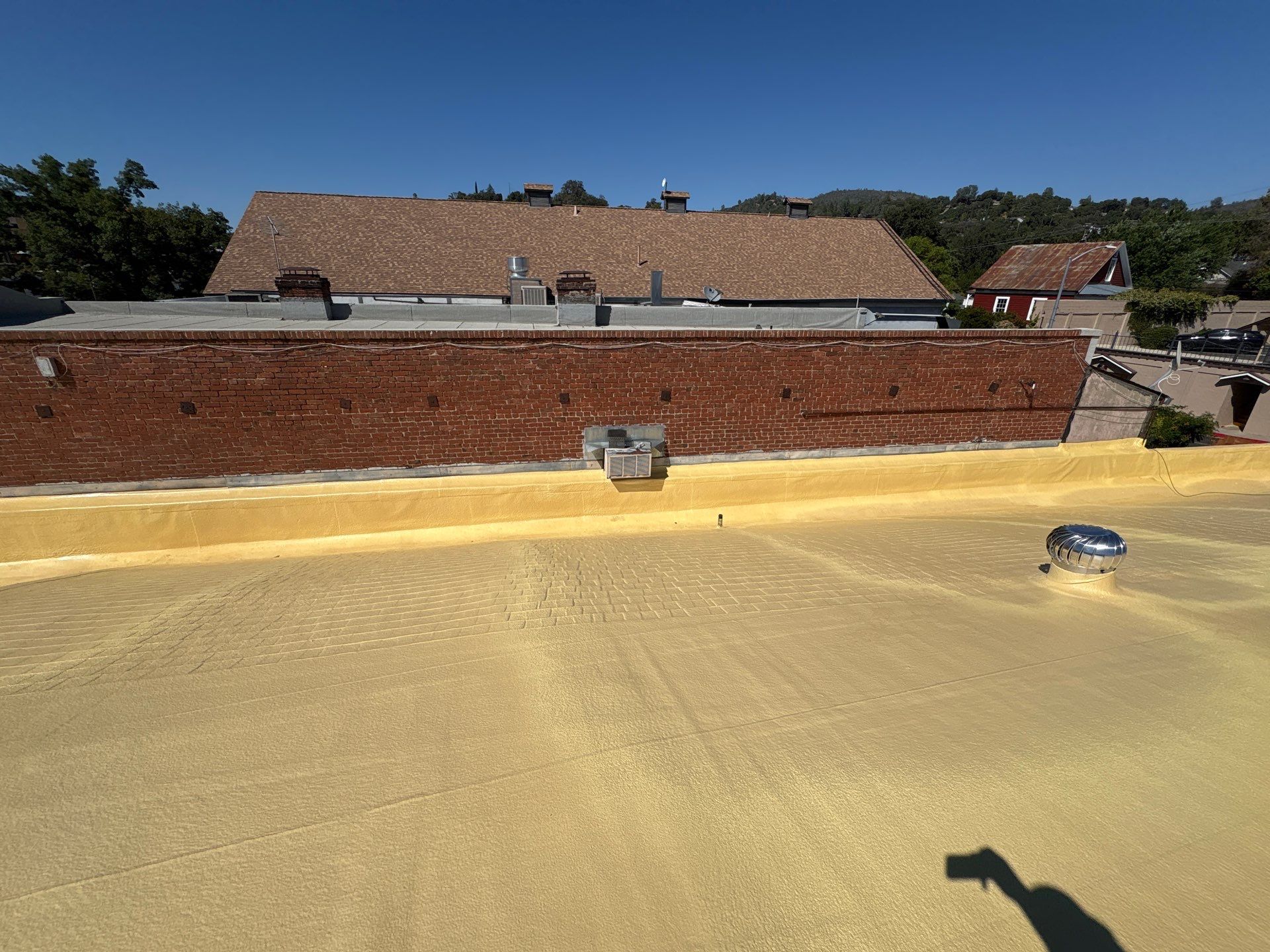 Foam and coatings on commercial roof by Straight Edge Roofing Inc