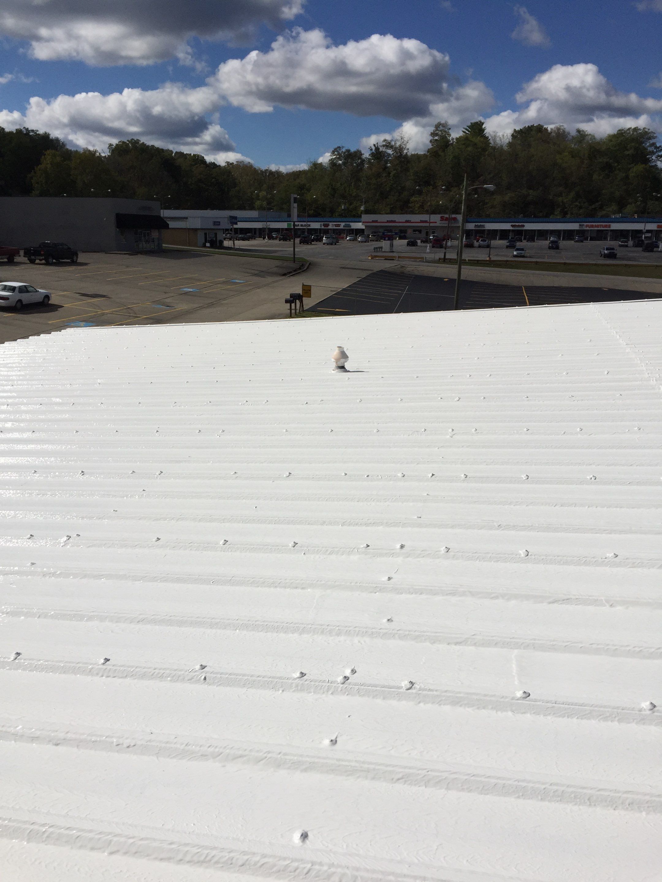 Commercial Roof Coating using Gaco Silicone Roof Coating by Secure Construction Company Inc