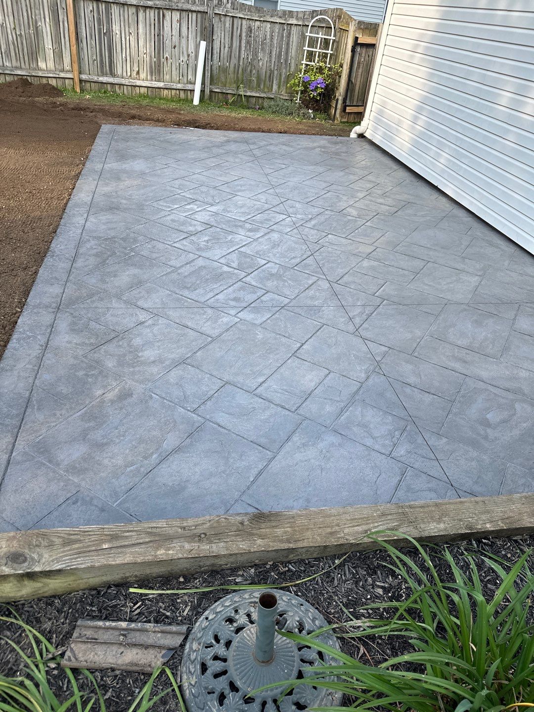 Majestic Ashlar stamped concrete patio with a border  by NG Masonry & Construction LLC