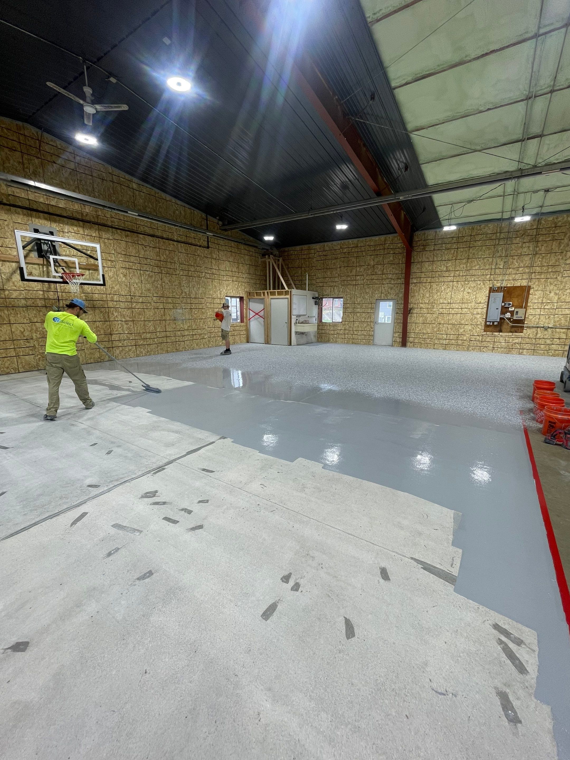 Custom Polyurea Shop Floor with Basketball Court Lines in Rock Valley by Select Painting, Coatings & Garage Cabinets