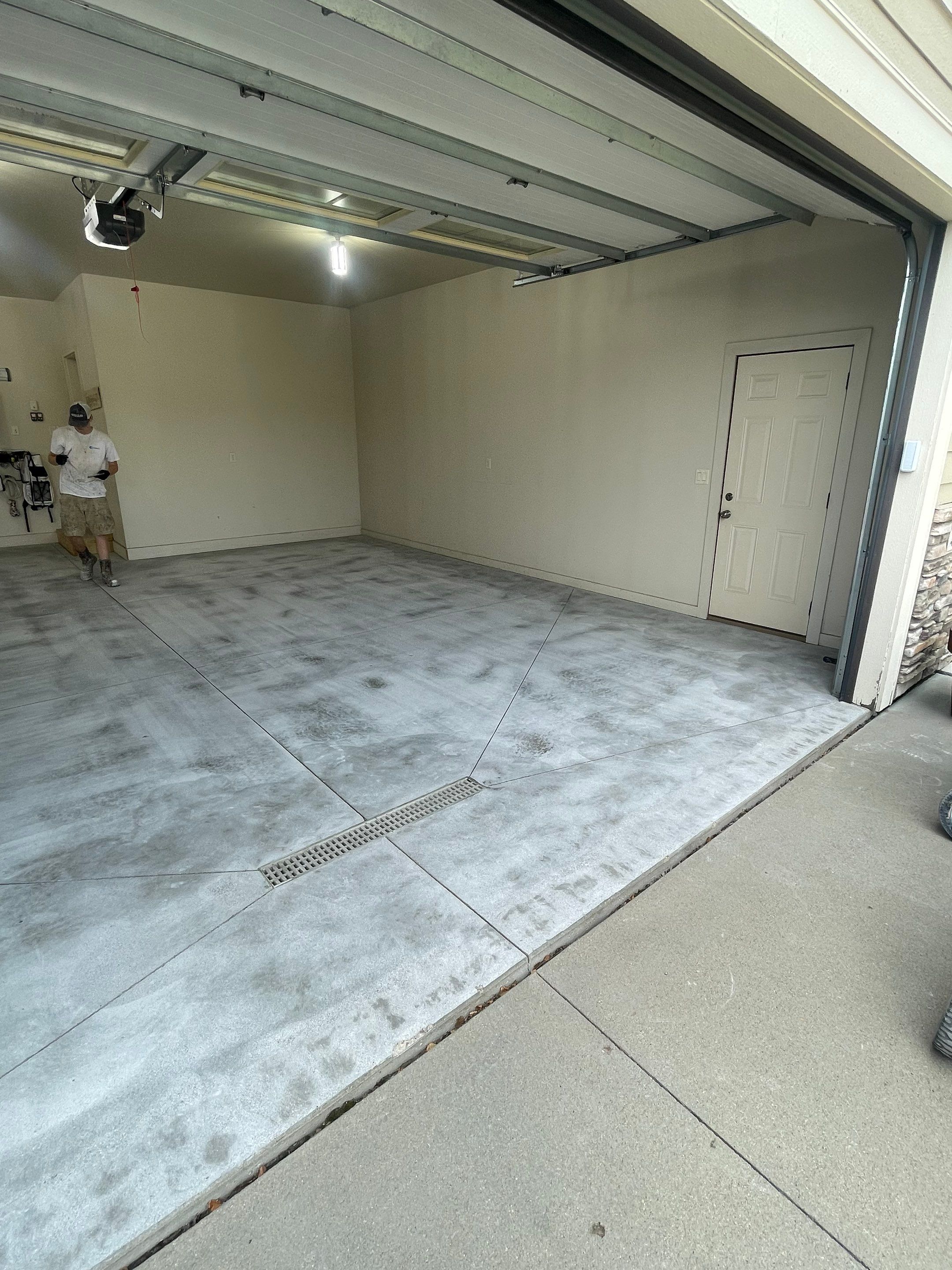 Coyote Flake Garage Floor Coating in Sioux Falls with Trench Drain by Select Painting, Coatings & Garage Cabinets