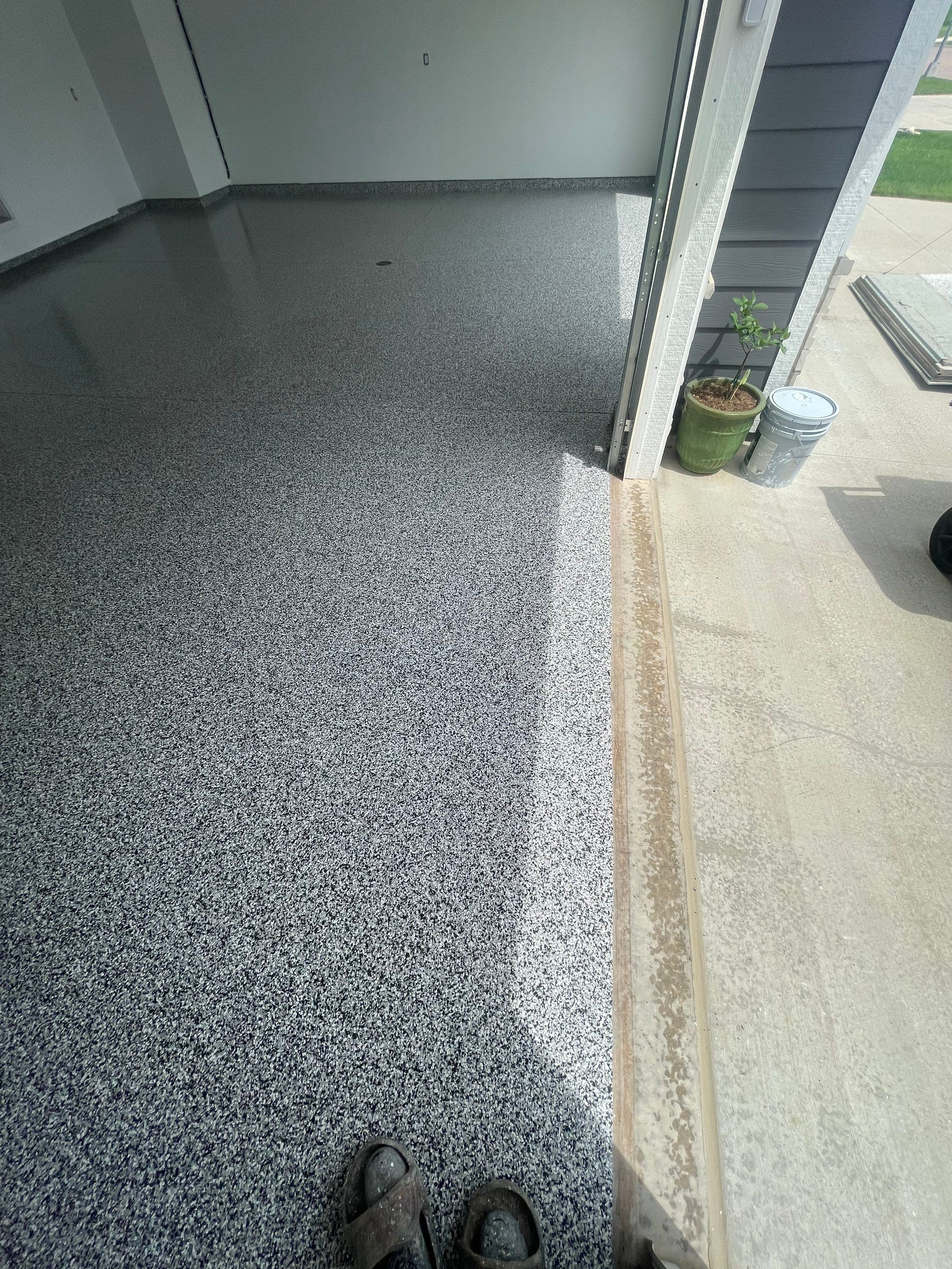 Grey Flake Epoxy Garage Floor Coating in Sioux Falls by Select Painting, Coatings & Garage Cabinets