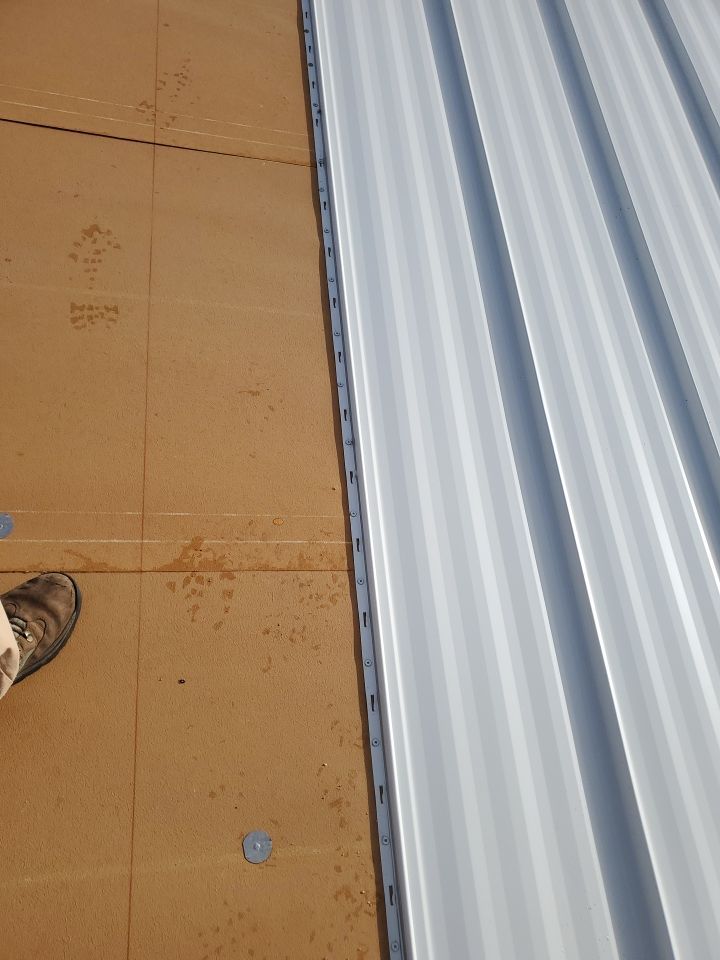 Residential Roofing Installation using 1.5" Nail Strip 24ga Solar White Kynar Coated Standing Seam Metal Panels by Morton Roofing, Inc.