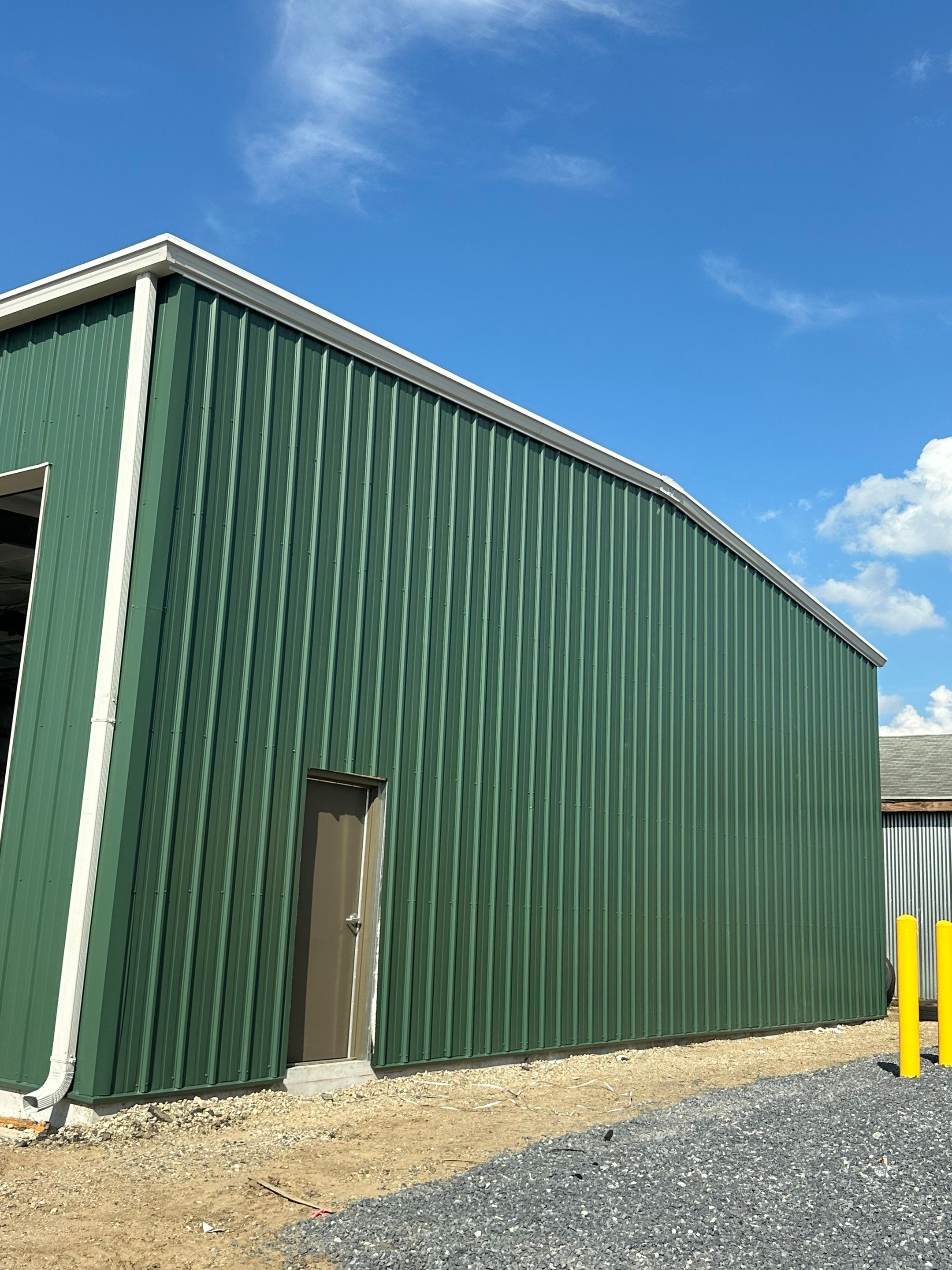 Dark Green Metal Siding by Reimagine Roofing