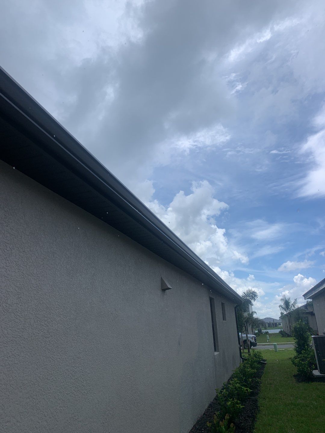 Seamless brown gutter and downspouts installation in Estero, FL  by Gutter Professors