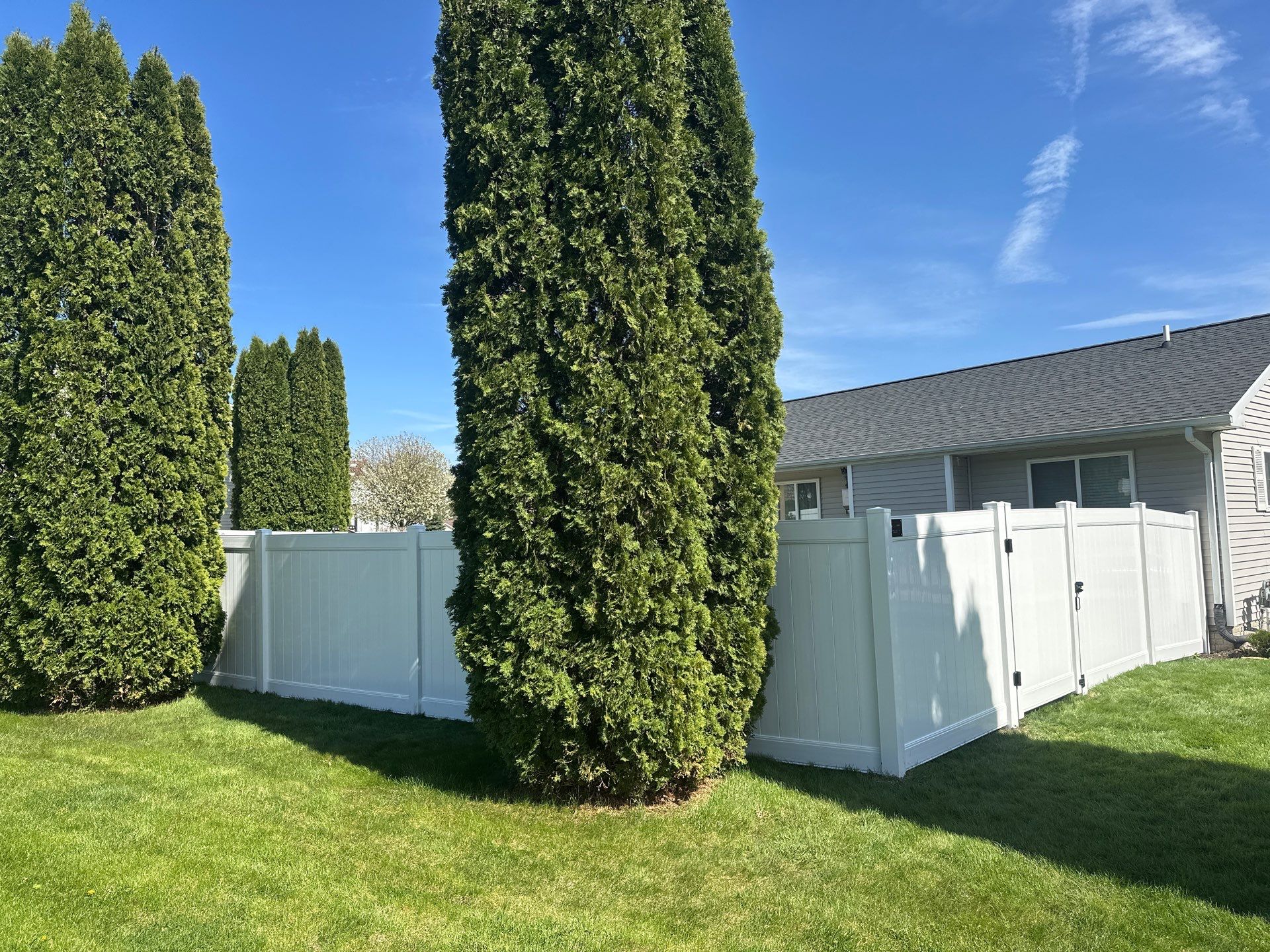 White Vinyl Privacy Fence Installation in Raymond, Iowa by Perfect Picket Fence and Stain