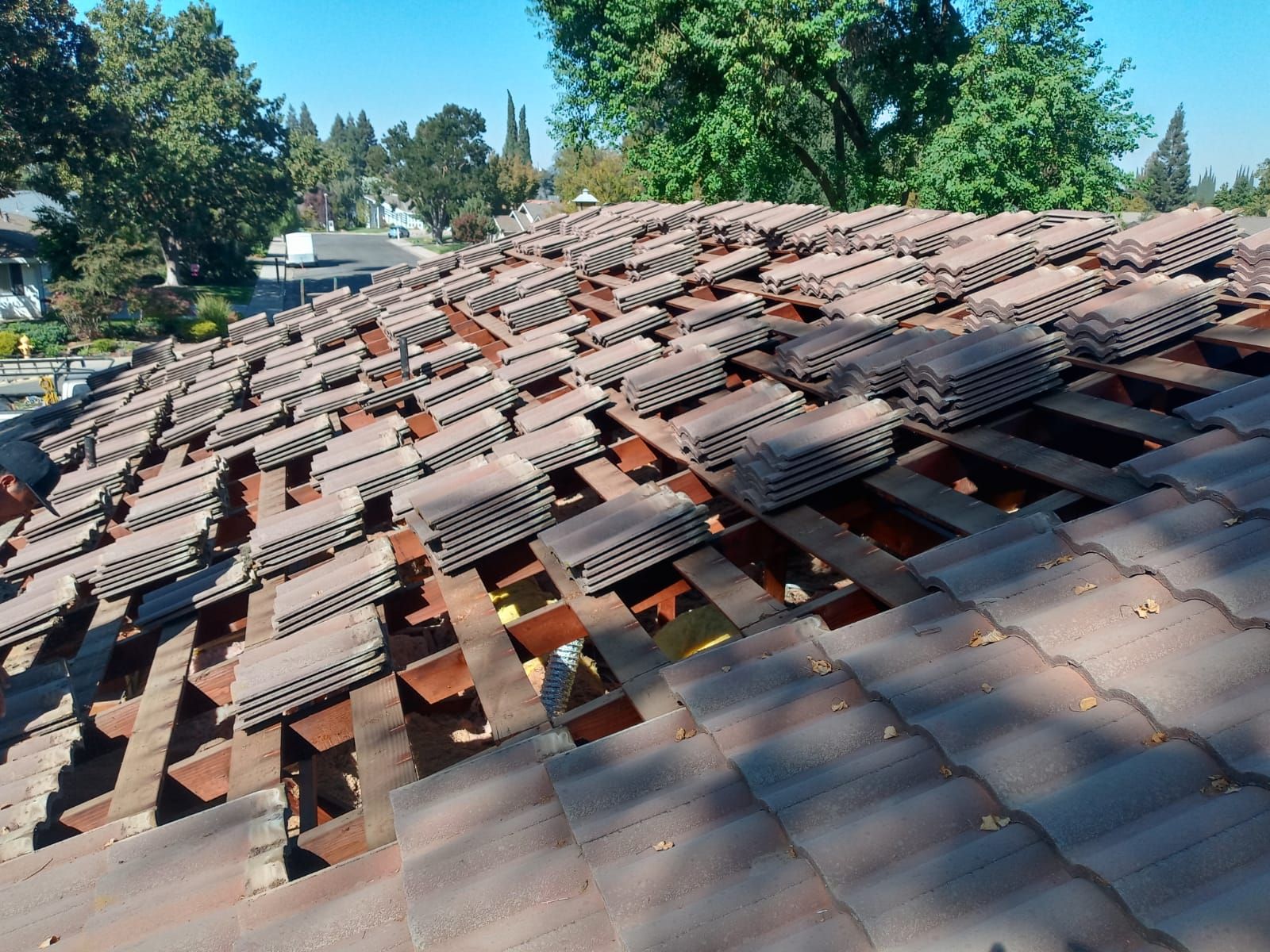 Tile roof remodel/ install OSB sheathing under tile and replace using OSB board with new underlayment, tile, and battens by Straight Edge Roofing Inc