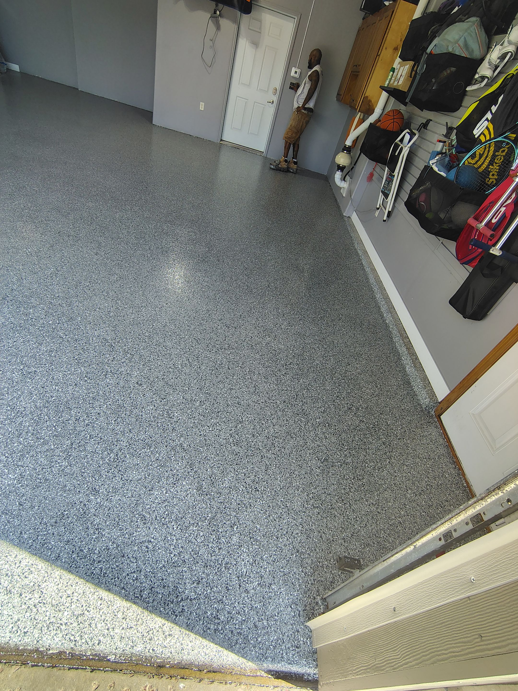 Grey Flecked Epoxy Garage Floor Installation in Sioux Falls by Select Painting, Coatings & Garage Cabinets