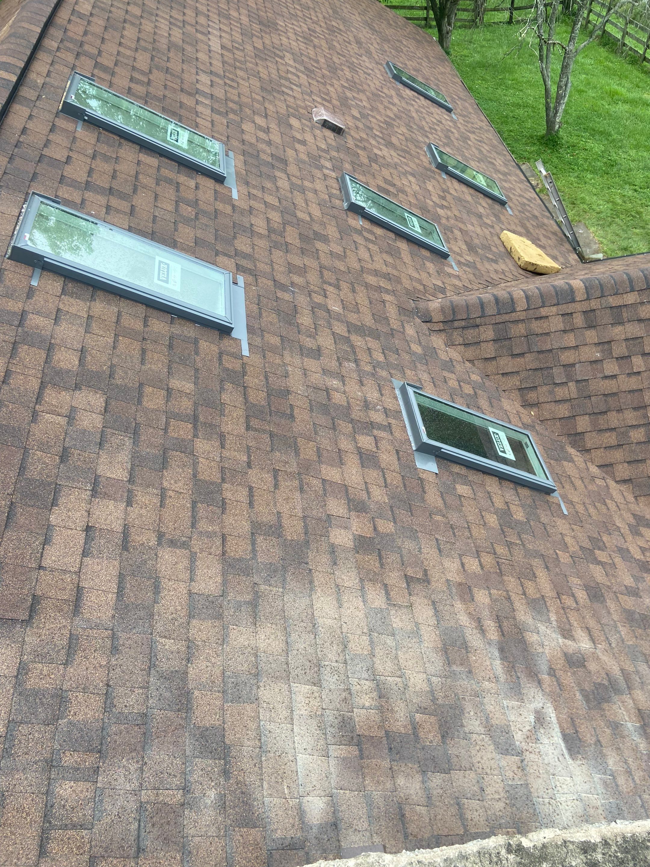 Shingle Roofing with Velux Skylight replacement and stone chimney flashing by Secure Construction Company Inc