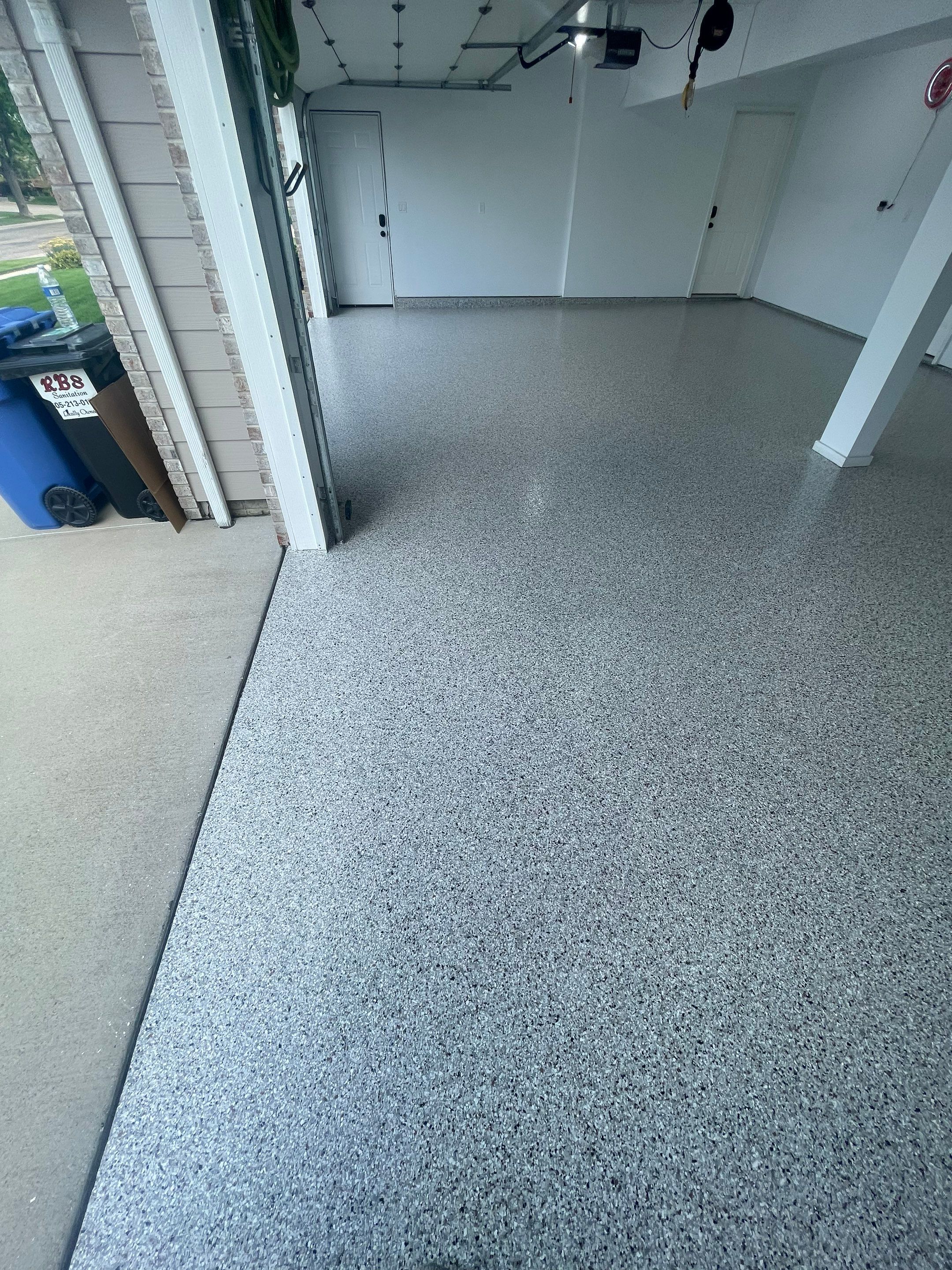 Multi-Car Garage Concrete Coating with Coyote Flake Finish in Sioux Falls by Select Painting, Coatings & Garage Cabinets