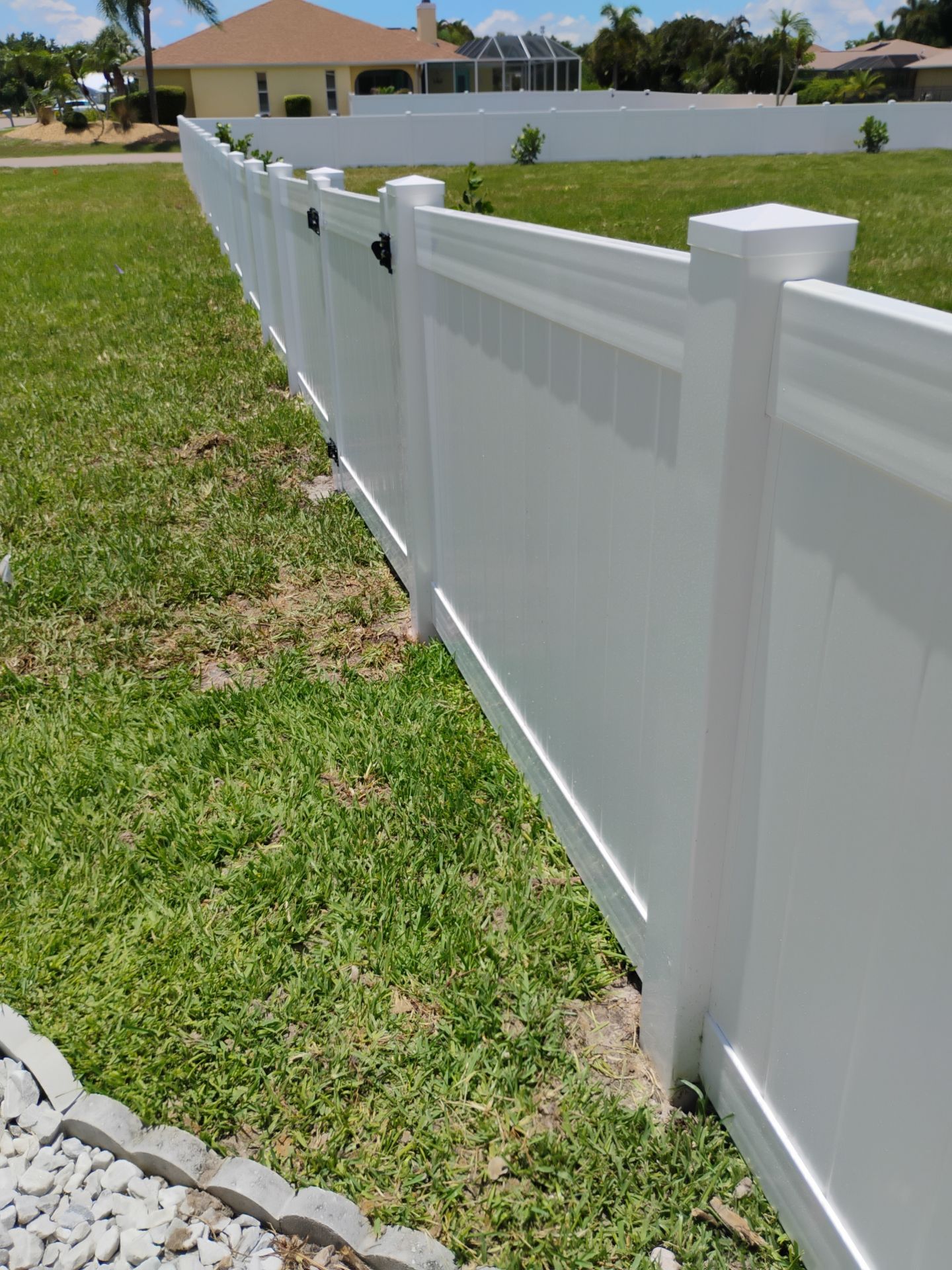 White Vinyl Privacy Fence Installation on Port Charlotte Corner Lot by True Fence LLC