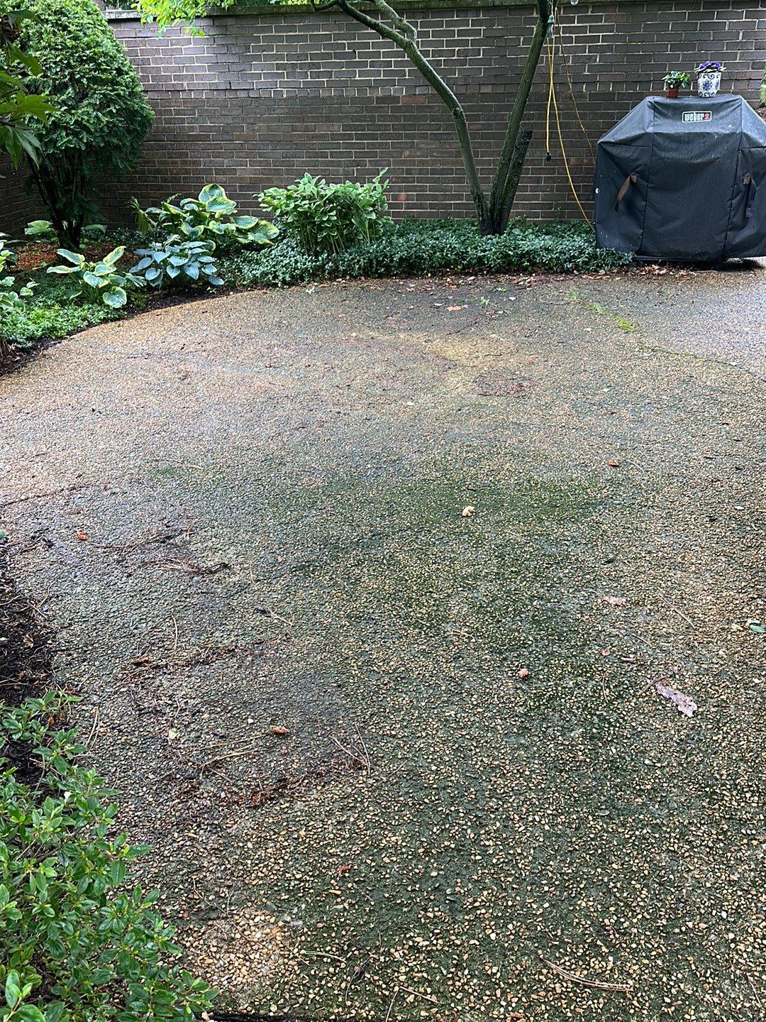 Aggregate and natural stone patio cleaning by Northern Power Washing LLC.