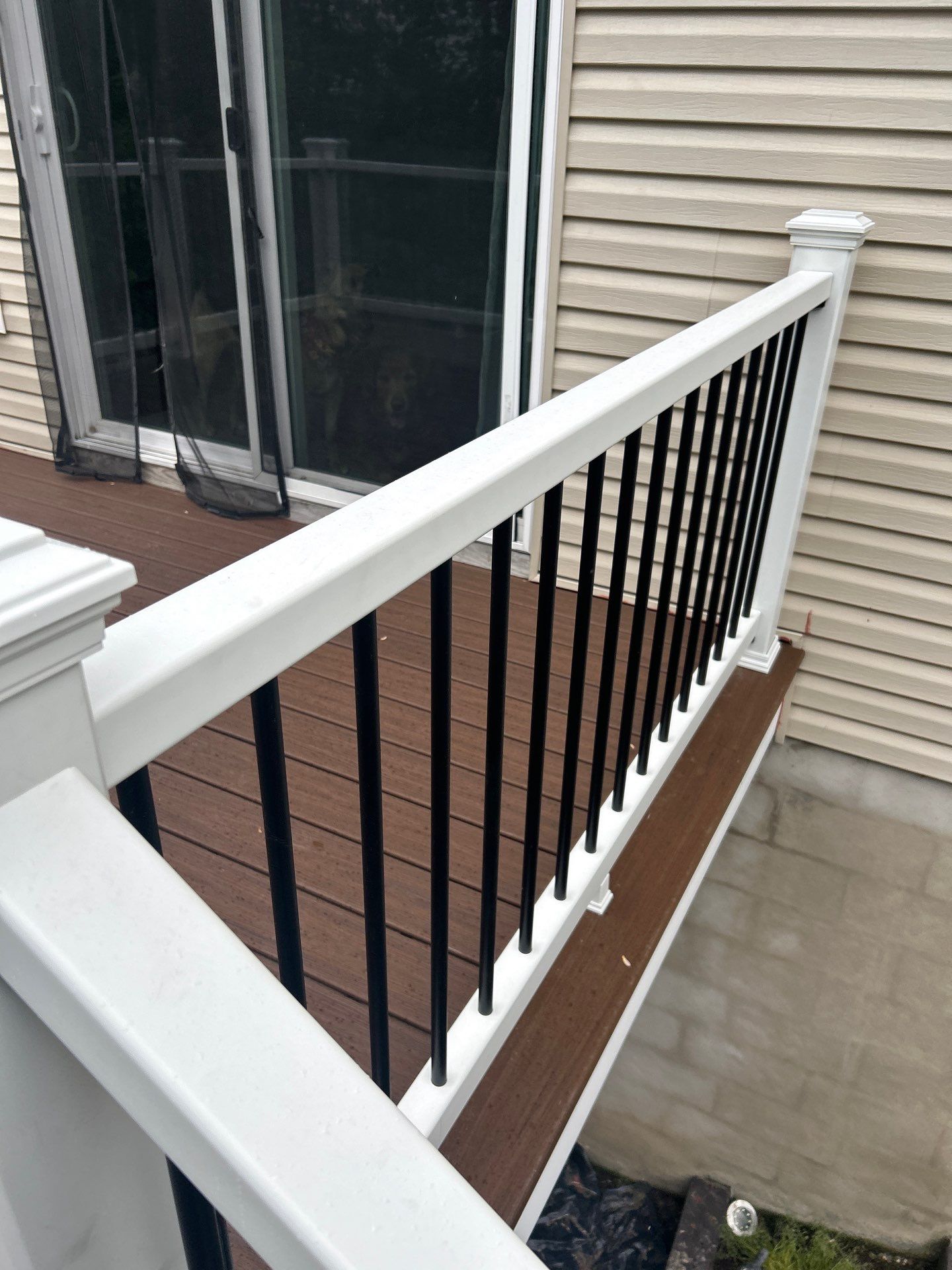 Elevated Composite Deck Replacement with White Railing in Tannersville by Herts Roofing & Construction