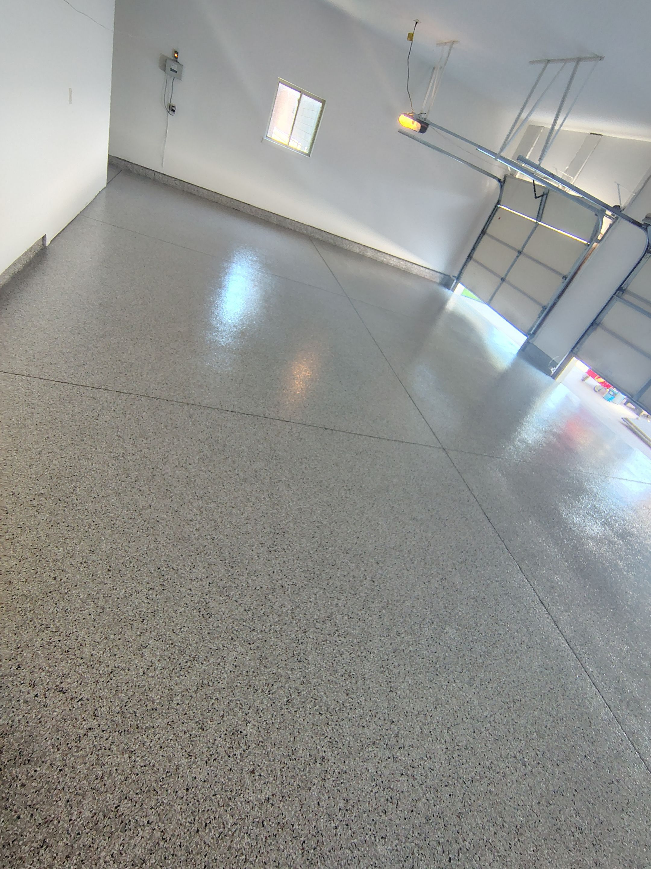 Custom Grey Speckled Epoxy Floor Coating for Sioux Falls Garage by Select Painting, Coatings & Garage Cabinets