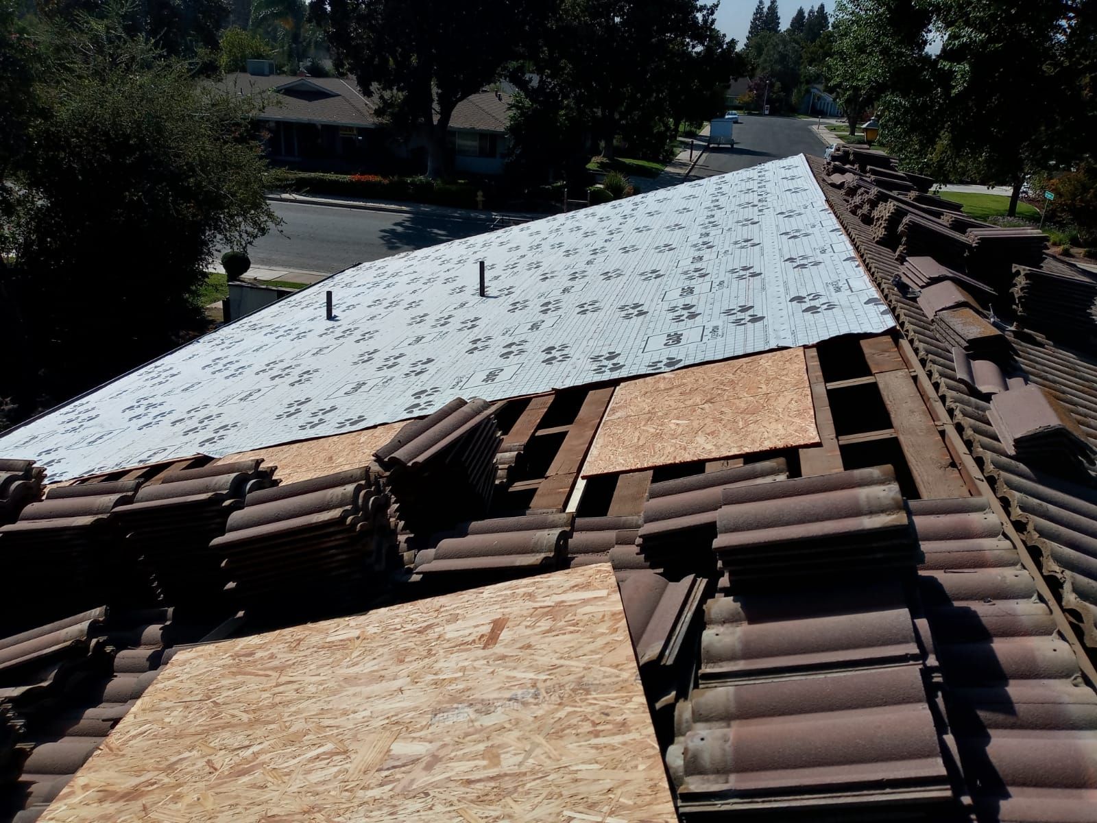 Tile roof remodel/ install OSB sheathing under tile and replace using OSB board with new underlayment, tile, and battens by Straight Edge Roofing Inc