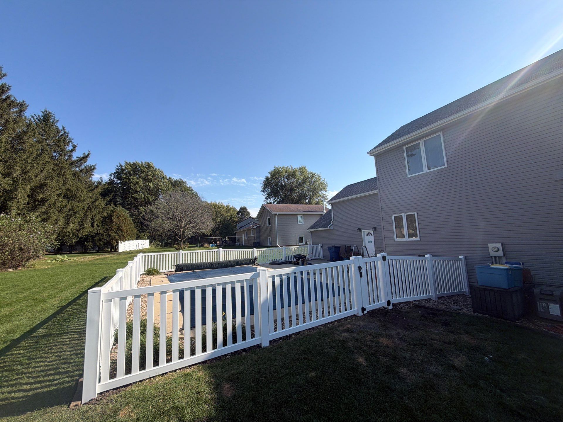 White Vinyl Picket Pool Fence Installation in Waterloo, Iowa by Perfect Picket Fence and Stain