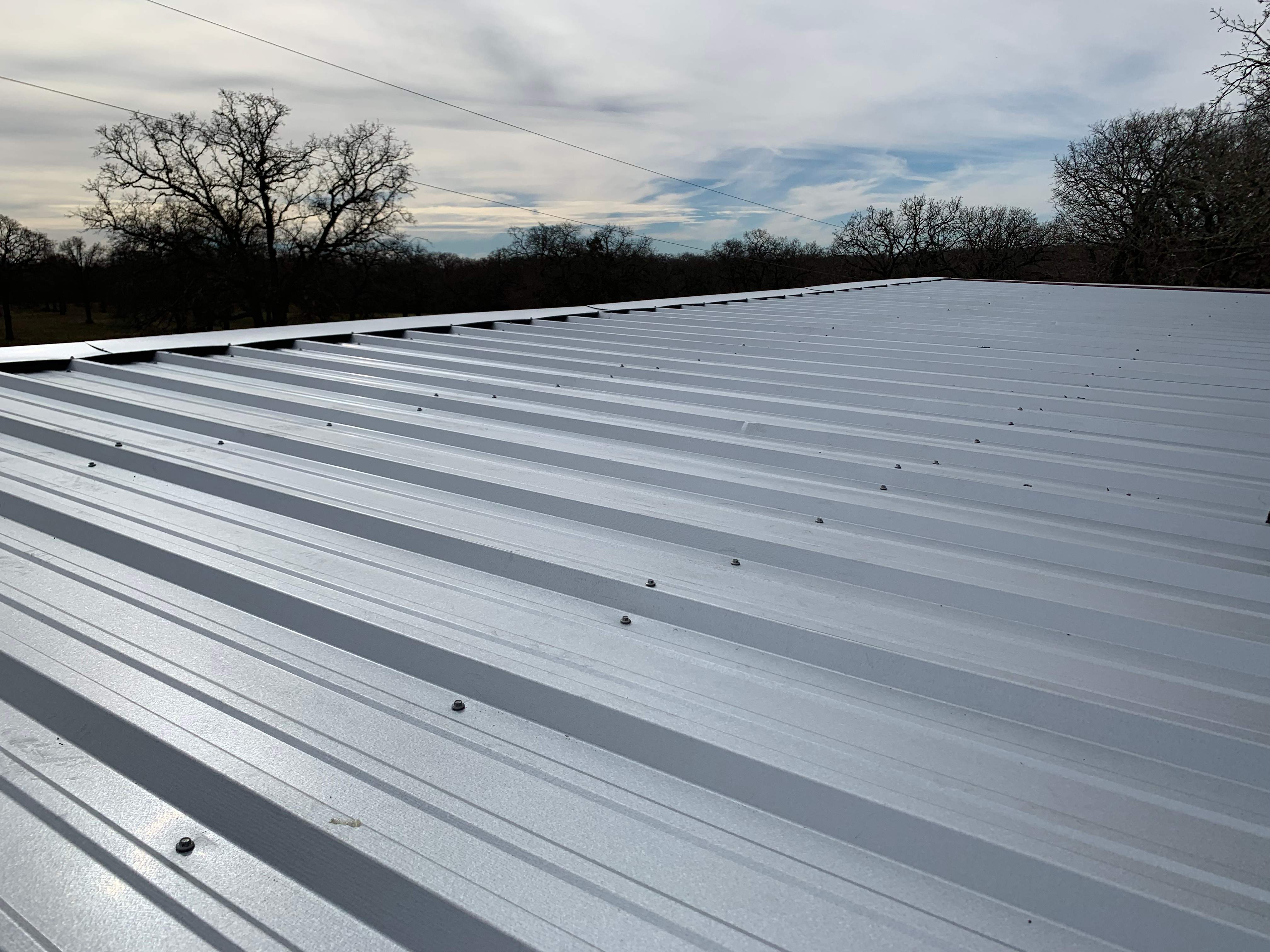 Install new R Panel Metal Roof at a Clients Farm house by First United Roofing & Construction