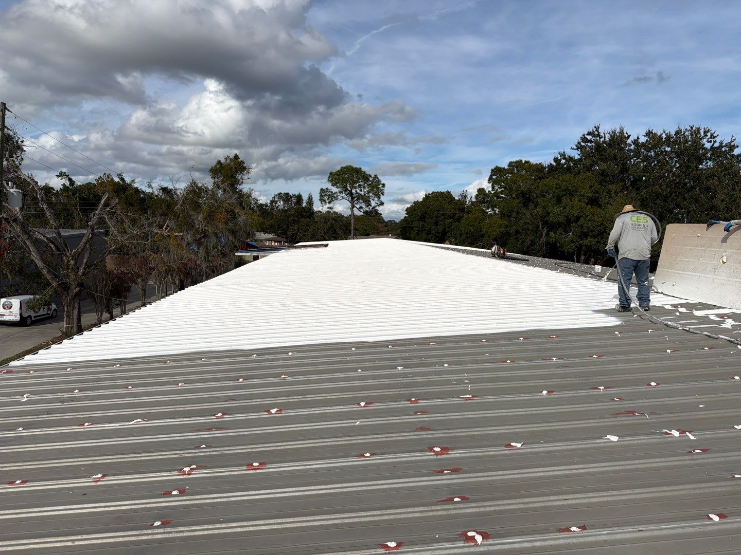 Industrial Metal Roof Restoration With Silicone Coating in Winter Park by CES Roofing