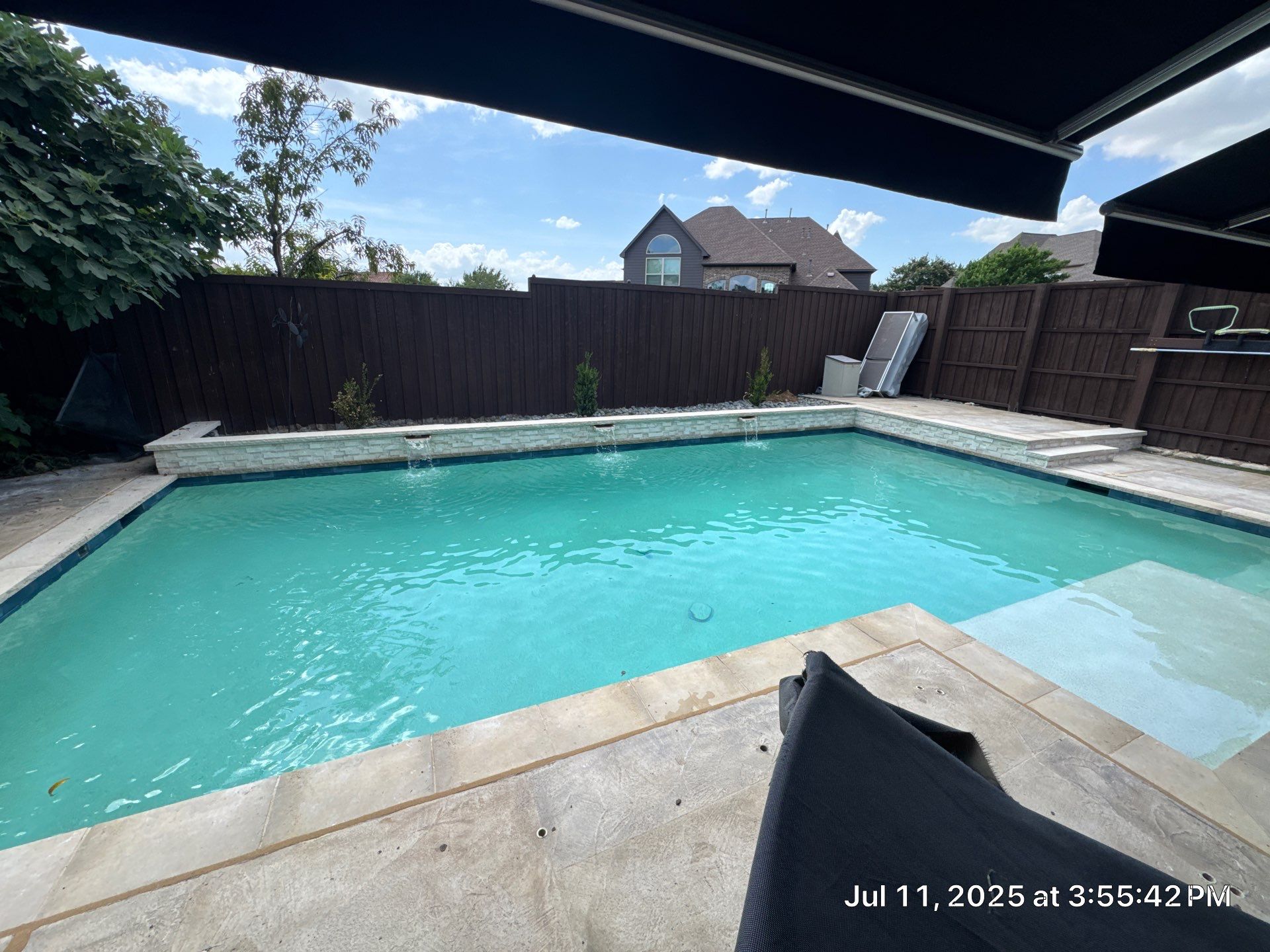 Geometric Pool with Raised Stone Waterfall Wall by Pinnacle Pools and Spas - DFW