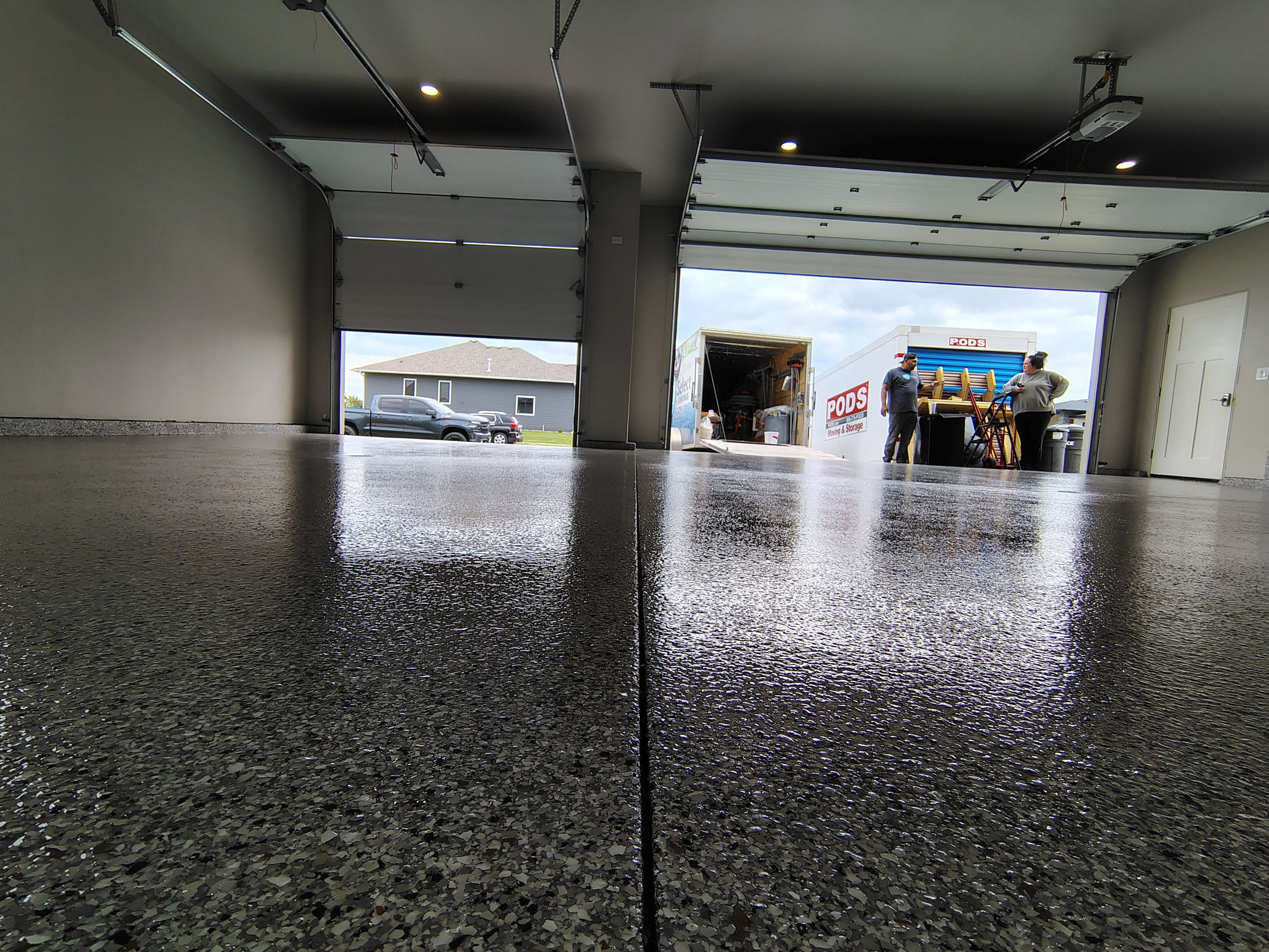 Grey Speckled Epoxy Garage Floor Coating in Sioux Falls by Select Painting, Coatings & Garage Cabinets