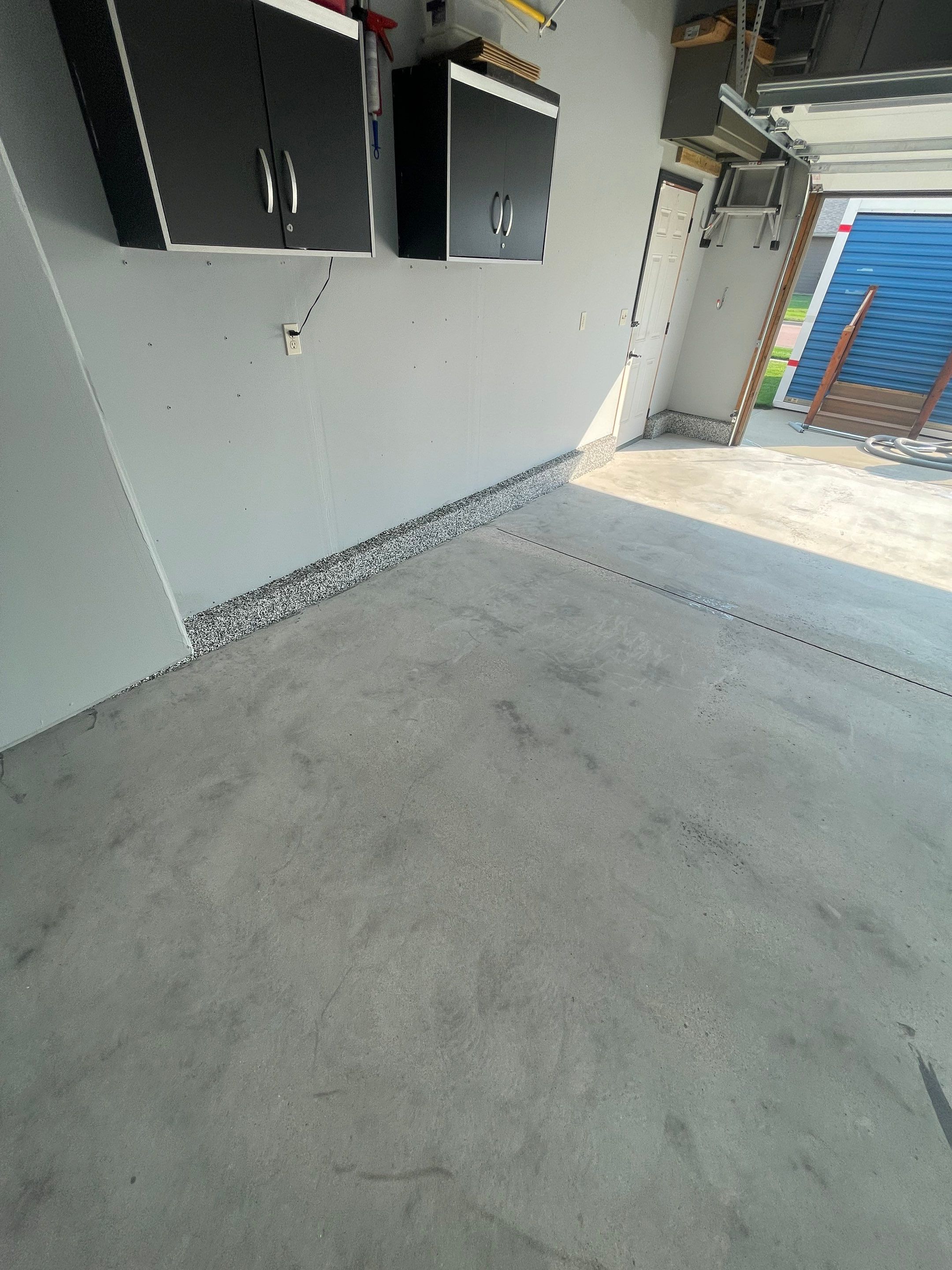 Sioux Falls Garage Concrete Coating Installation with Domino Flake by Select Painting, Coatings & Garage Cabinets