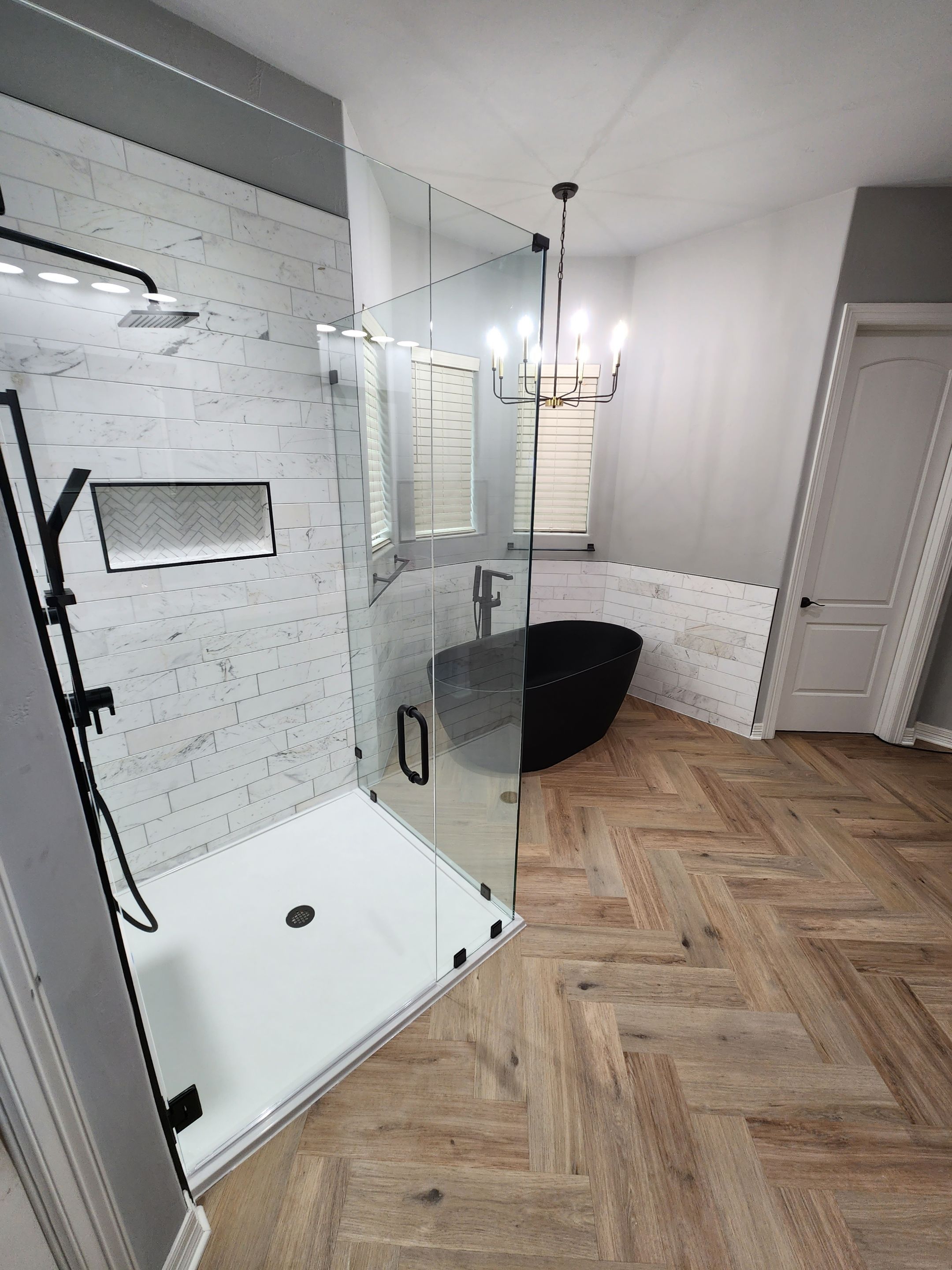 Spring Bathroom Remodel with Black Free-Standing Tub and Walk-In Shower by Legacy Bath and Kitchen