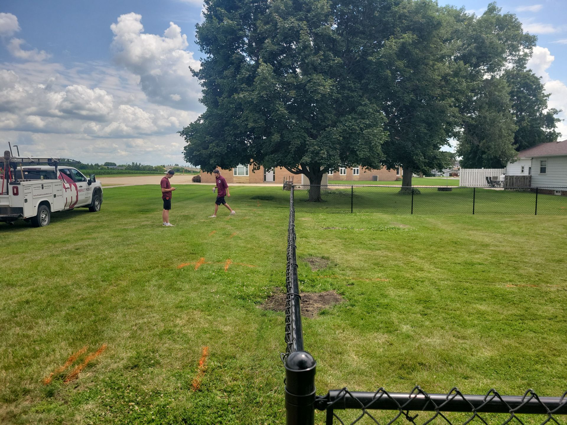 Residential Black Vinyl-Coated Chain Link Fence Installation in Allison by Perfect Picket Fence and Stain