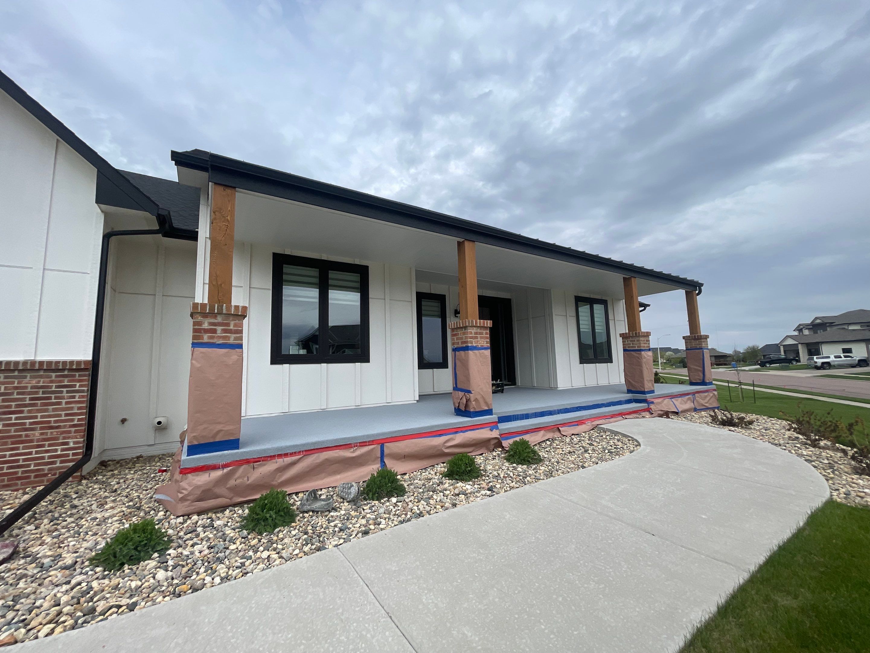 Grey Speckled Concrete Porch Coating for Sioux Falls Home by Select Painting, Coatings & Garage Cabinets